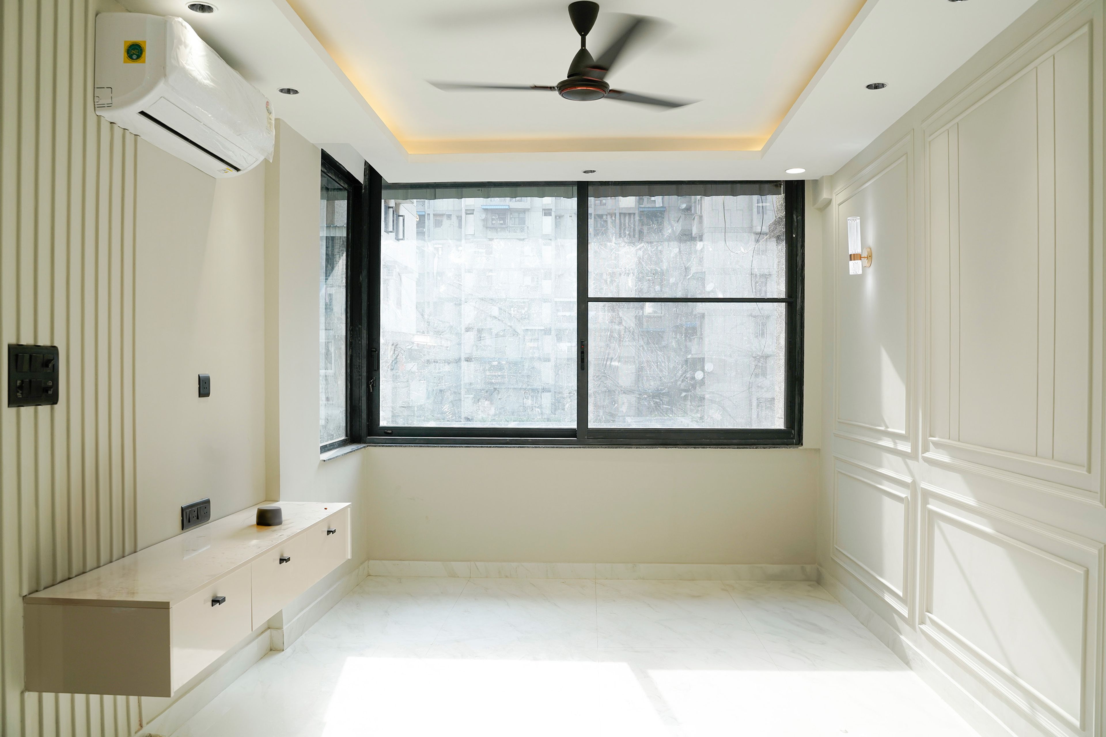 Bedroom Design with Wall Mounted Cream TV Unit and Off-White Wall with Trims