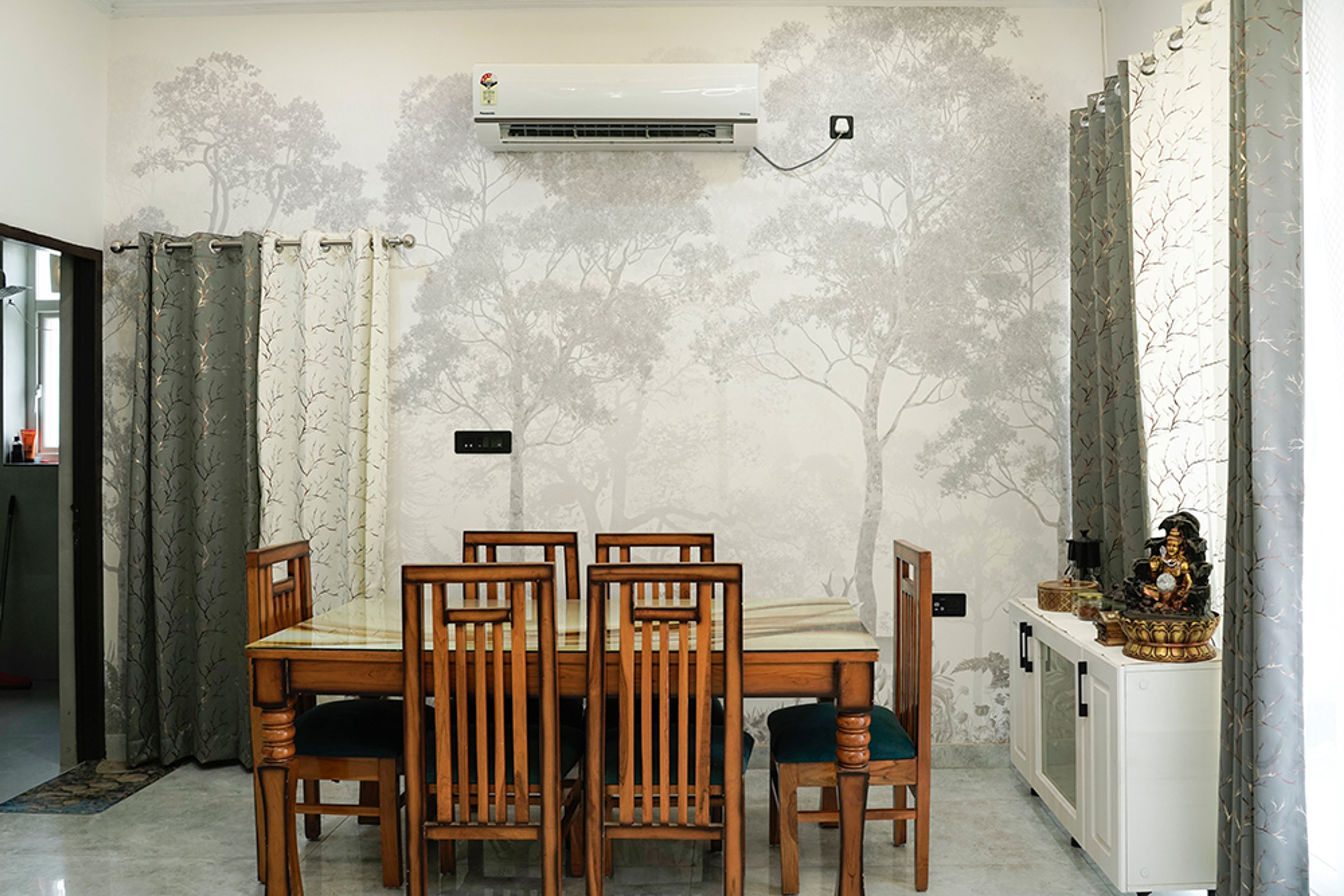 Dining Room Design with Wooden Dining Table and Tree-Themed Wallpaper