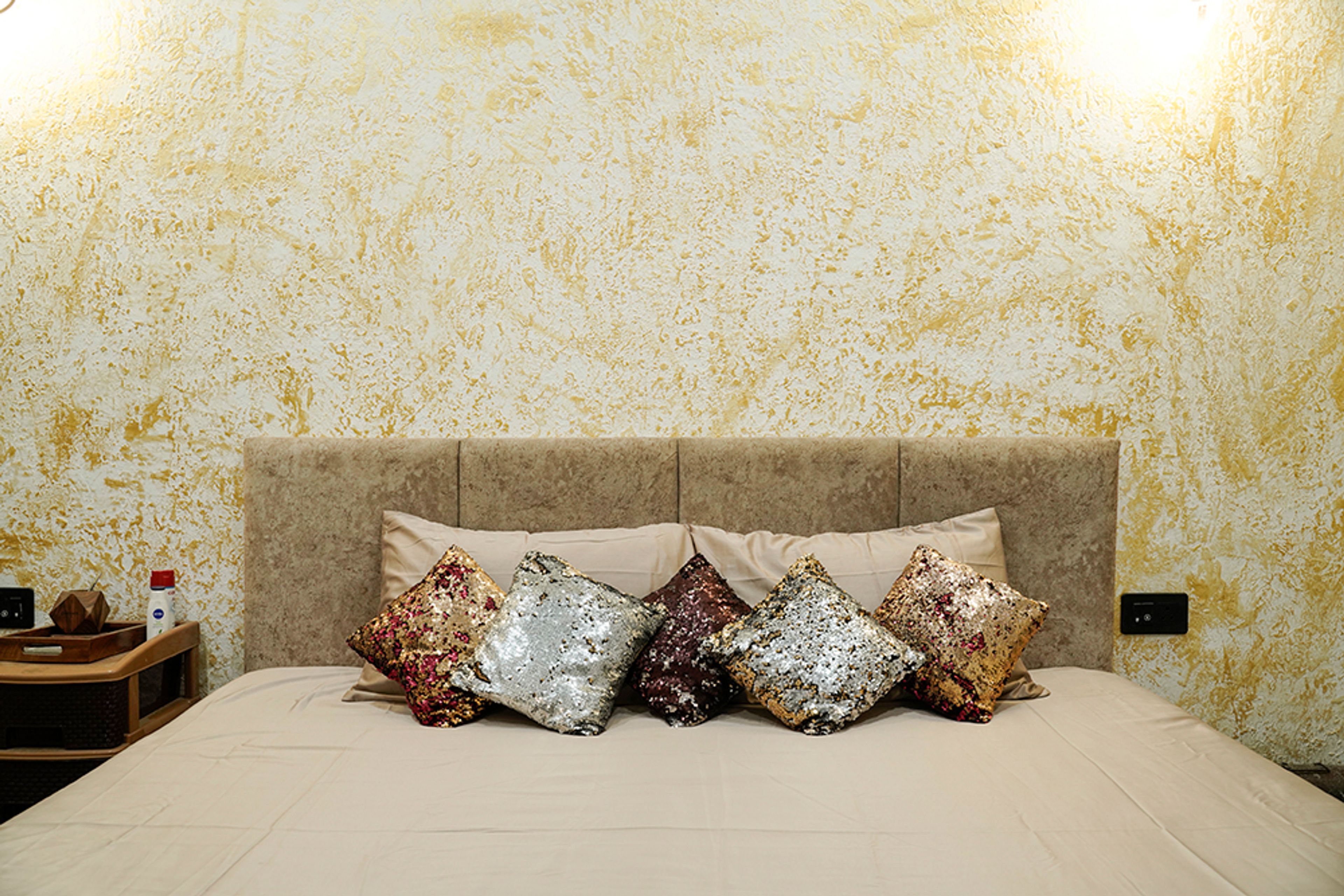 Master Bedroom Design with Beige Upholstered Headboard and Textured Yellow Wall Paint