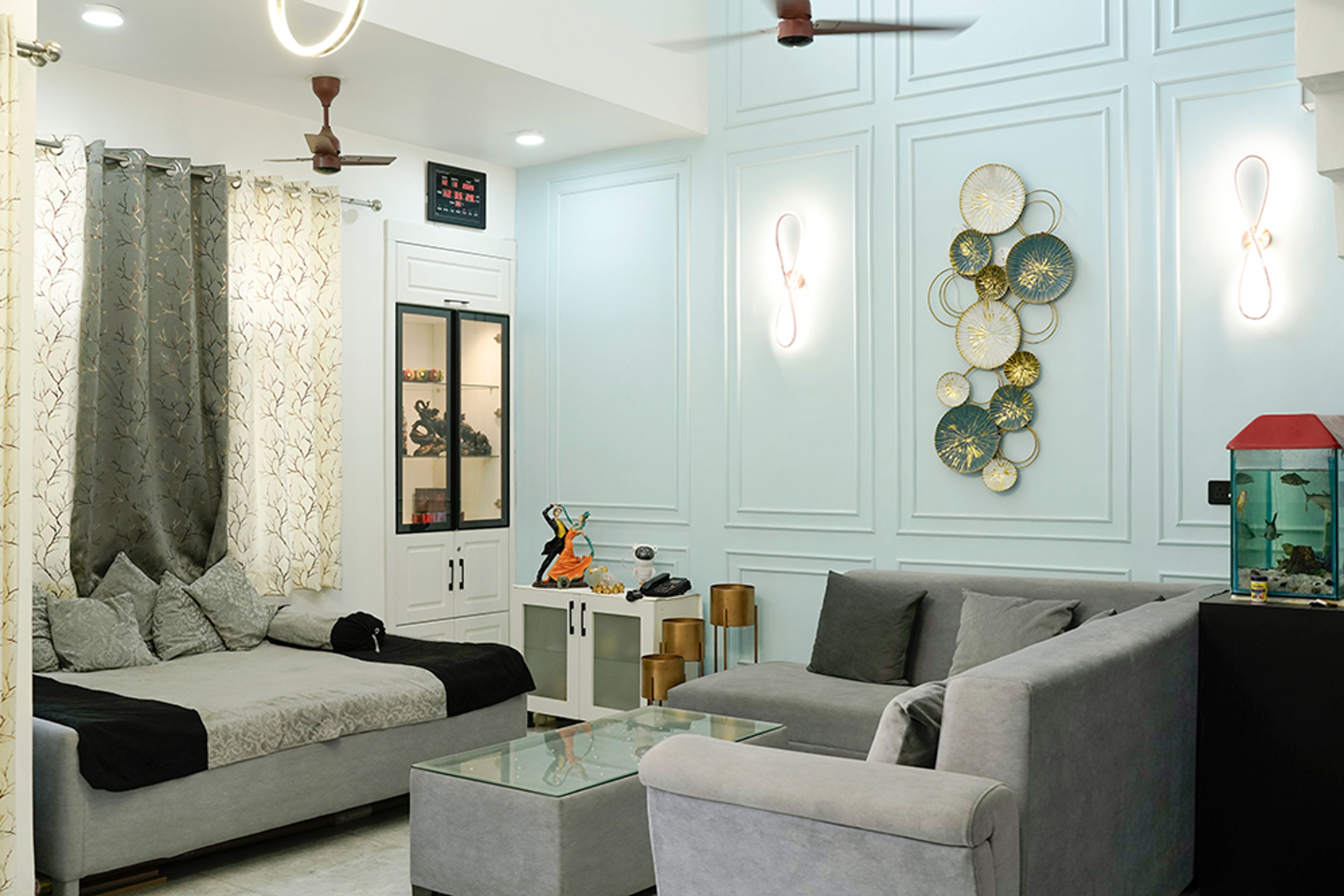 Living Room Design with Grey Sofas and Blue Wall with Trims and White Display Unit