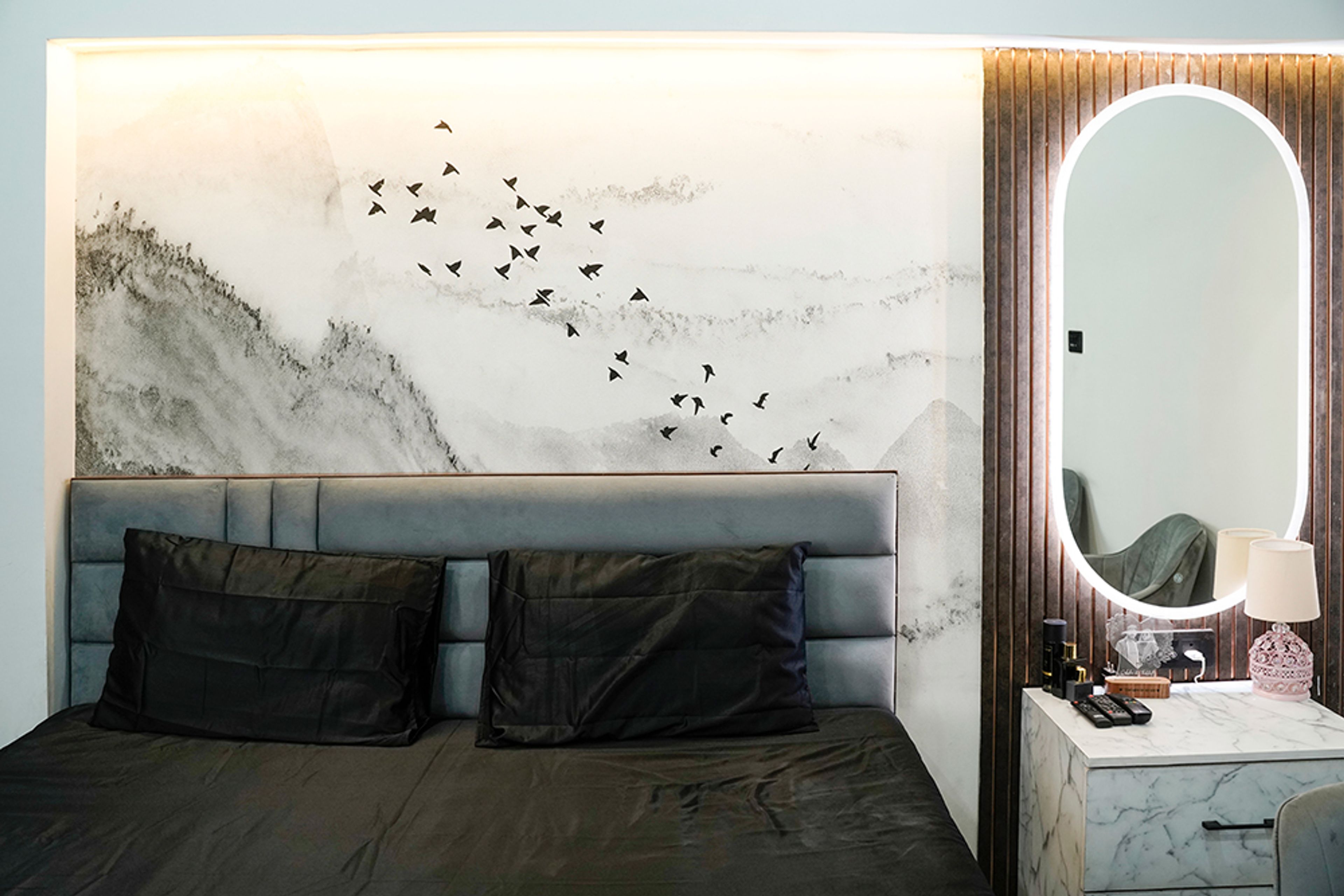 Master Bedroom Design with Bird-Themed Wall Art and Oval Mirror Dressing Unit