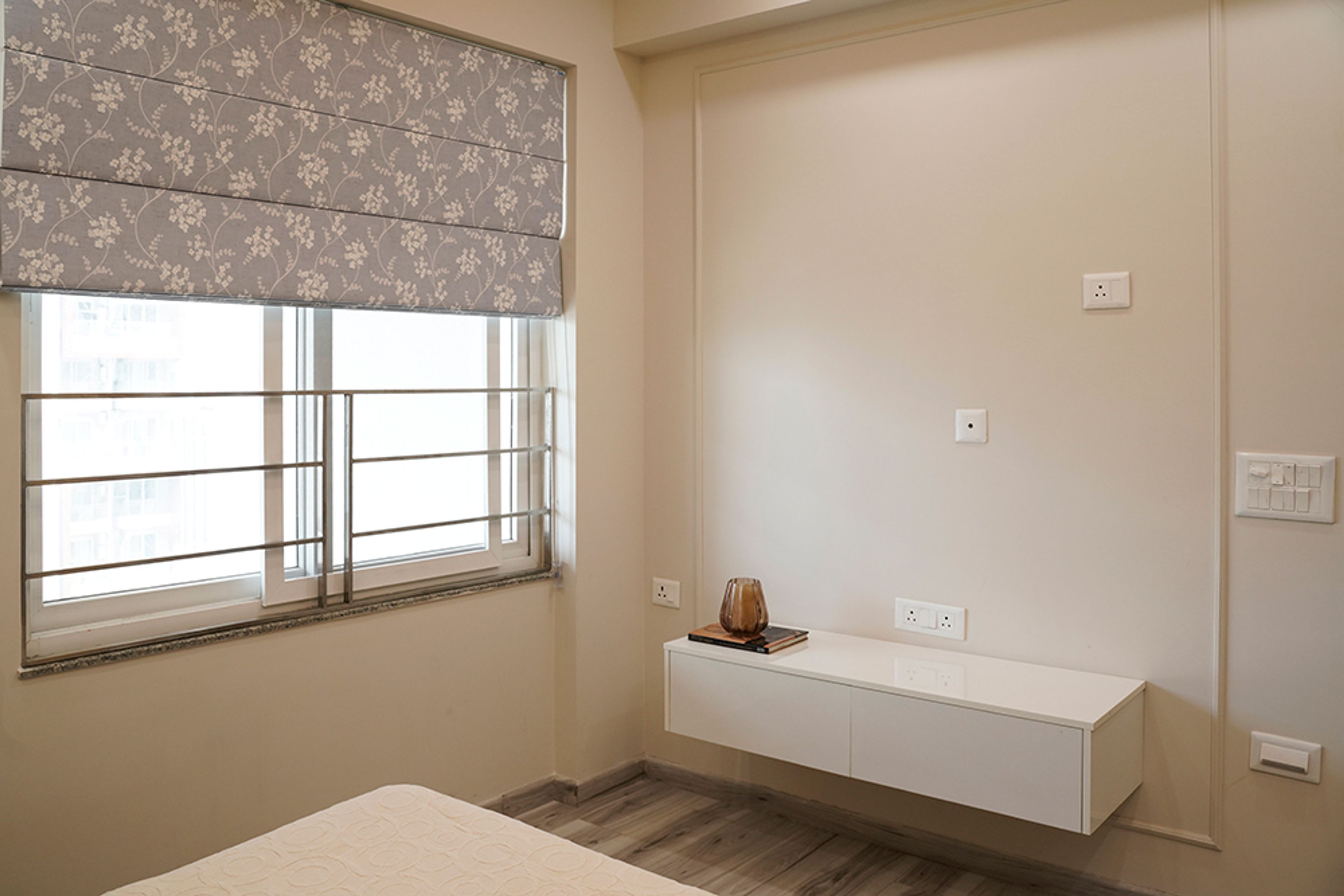 Modern Bedroom Design with White TV Unit in Noida 4BHK Apartment
