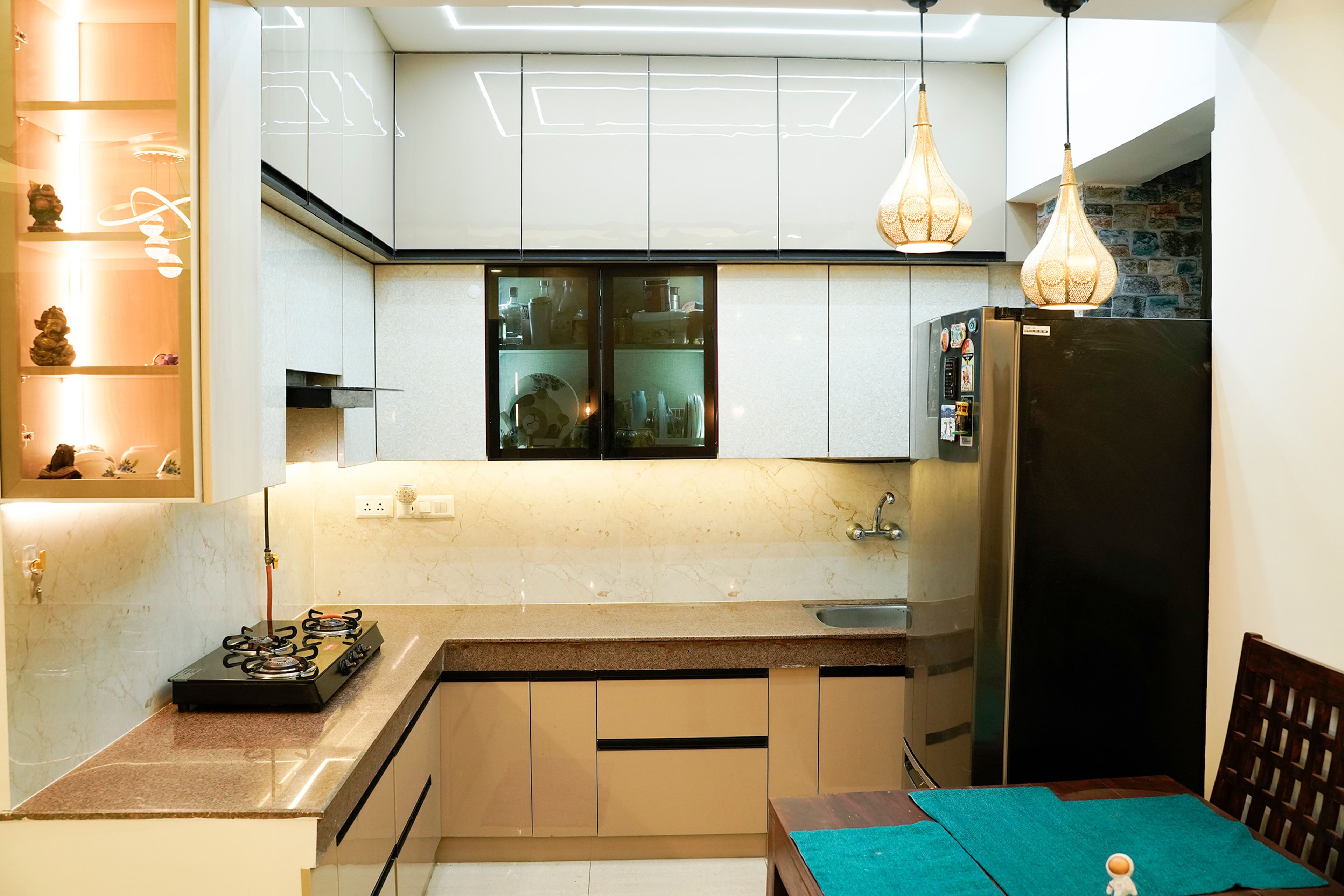 L-Shaped Kitchen Design with White Cabinets and Display Unit with Lighting Inside