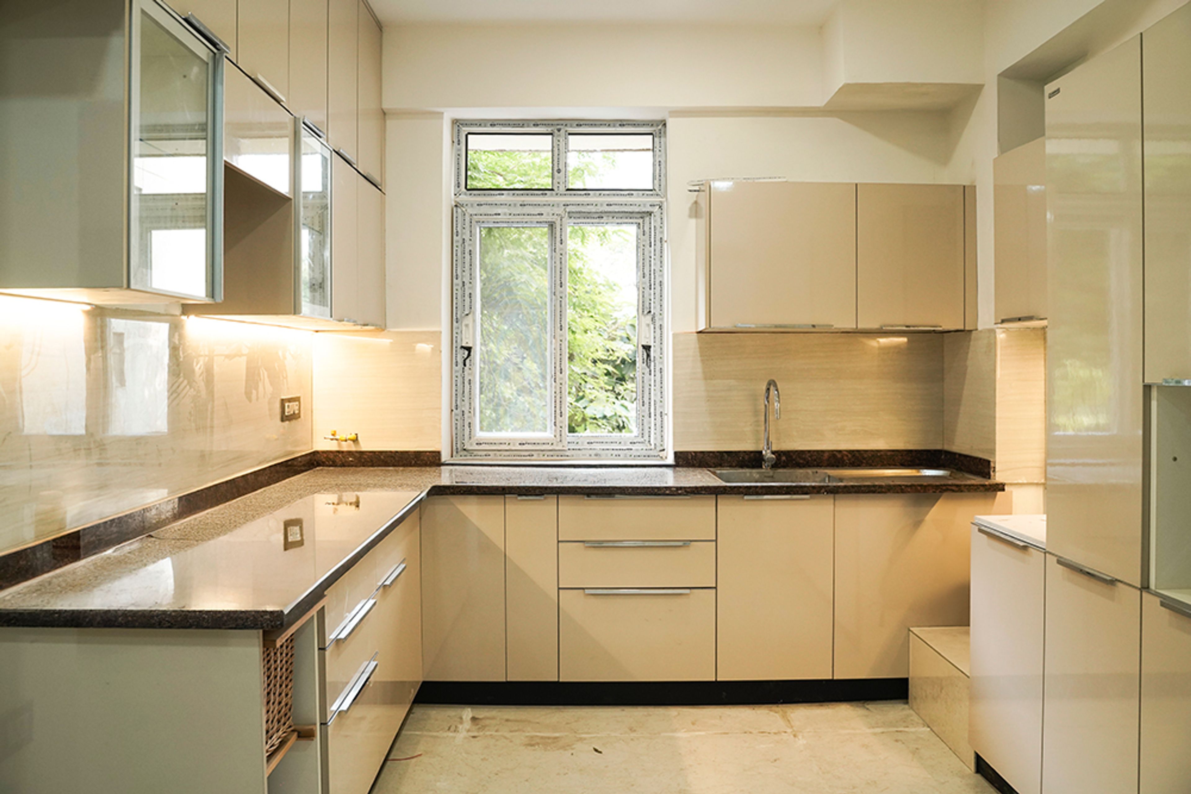 L-Shaped Kitchen Design with Cream Units and Under Cabinet Lighting