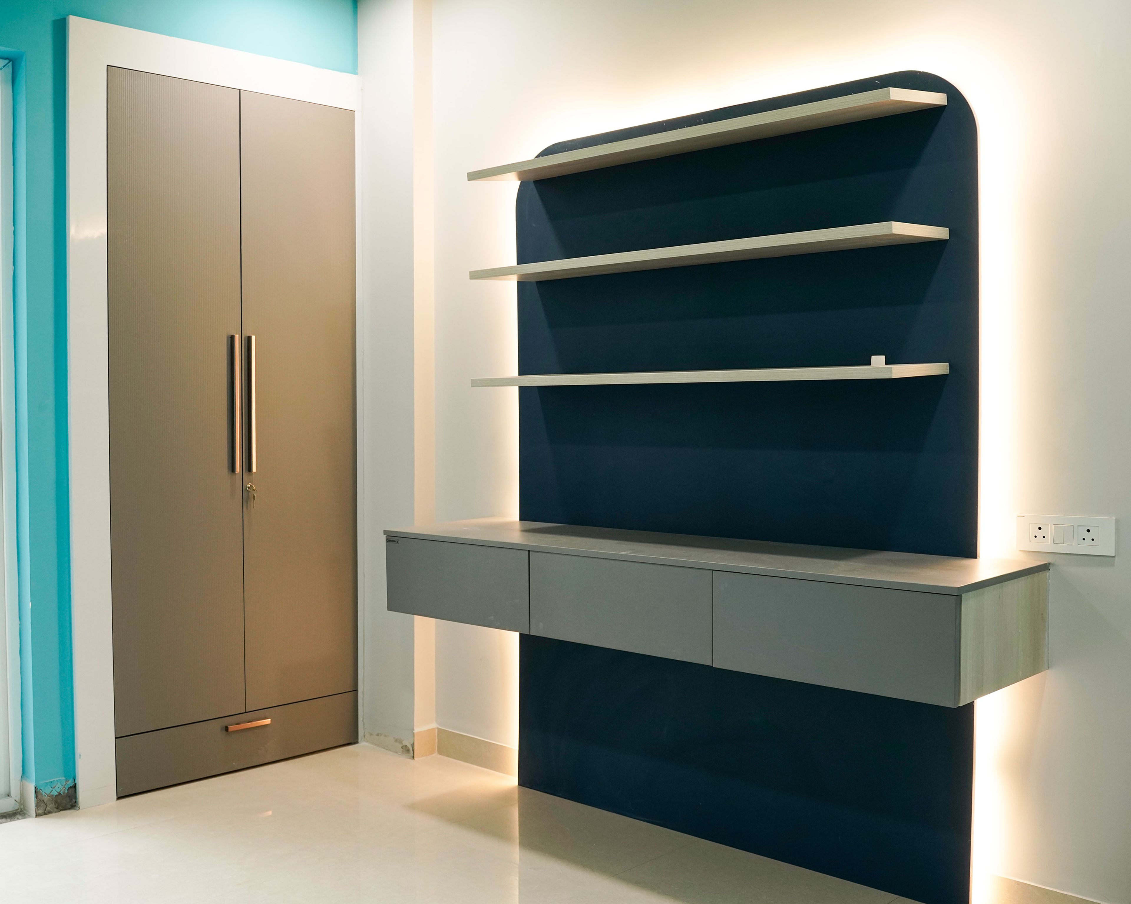 Grey Study Unit with Wall Mounted Opem Shelves with Blue Bakcground Wall and 2-Door Brown Swing Wardrobe