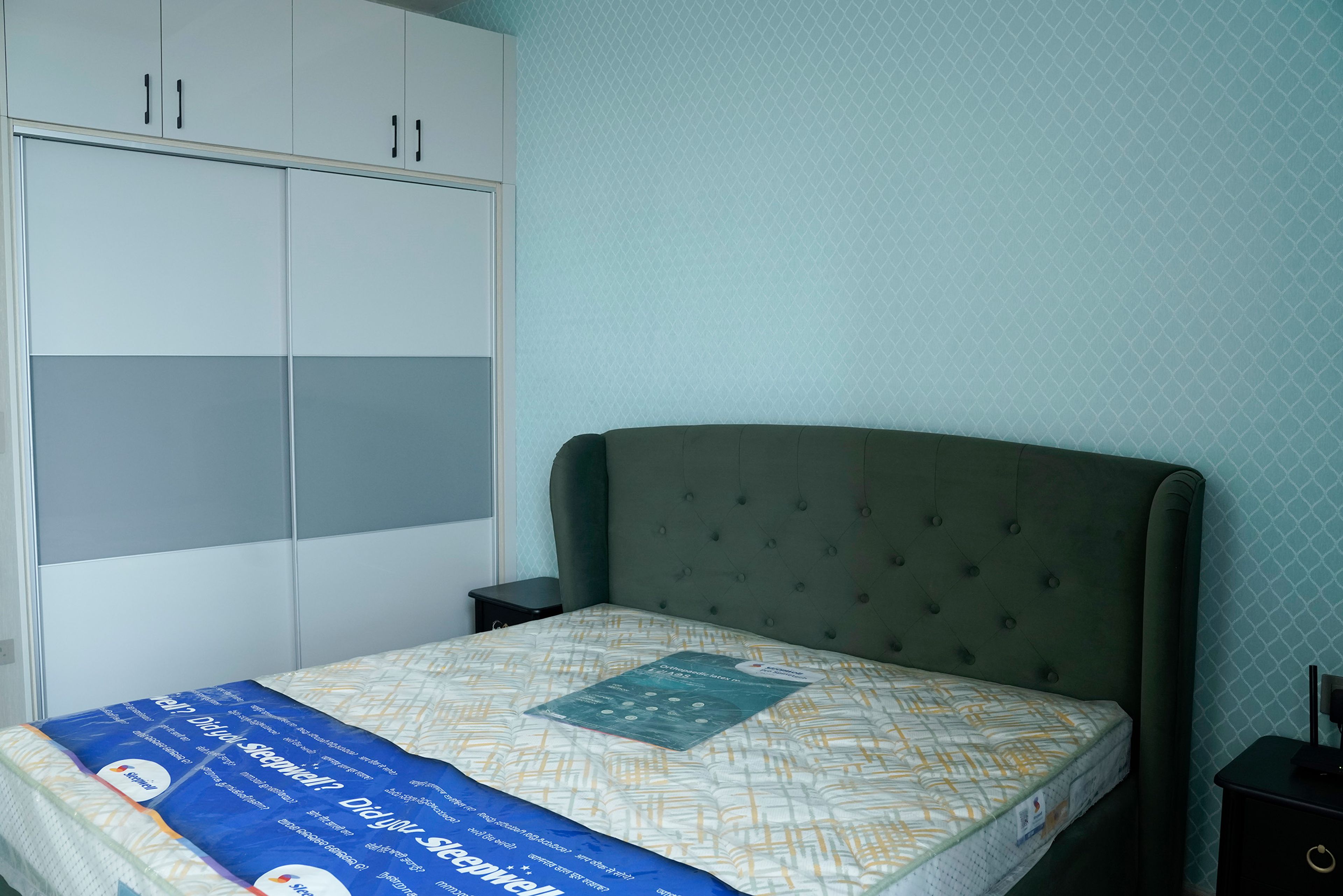 Bedroom Design with Blue Geometric Print Wallpaper and 2-Door Grey Sliding Wardrobe