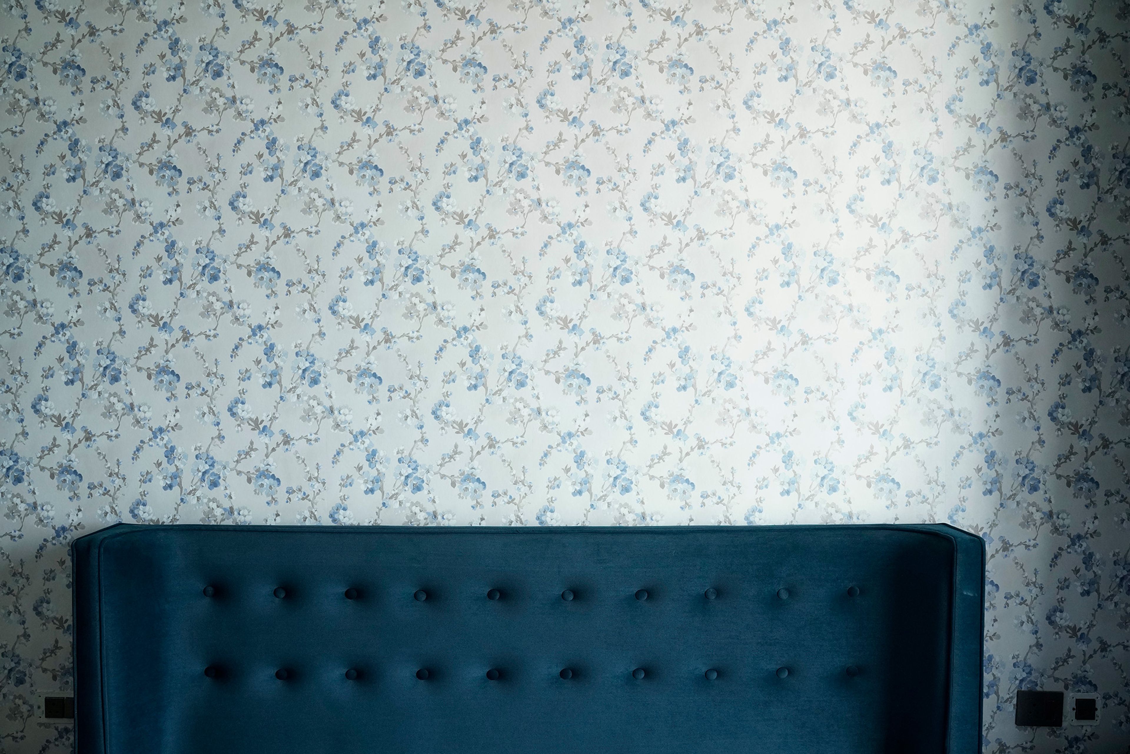 Blue and Grey Floral Pattern Wallpaper and Teal Tufted Headboard Bed