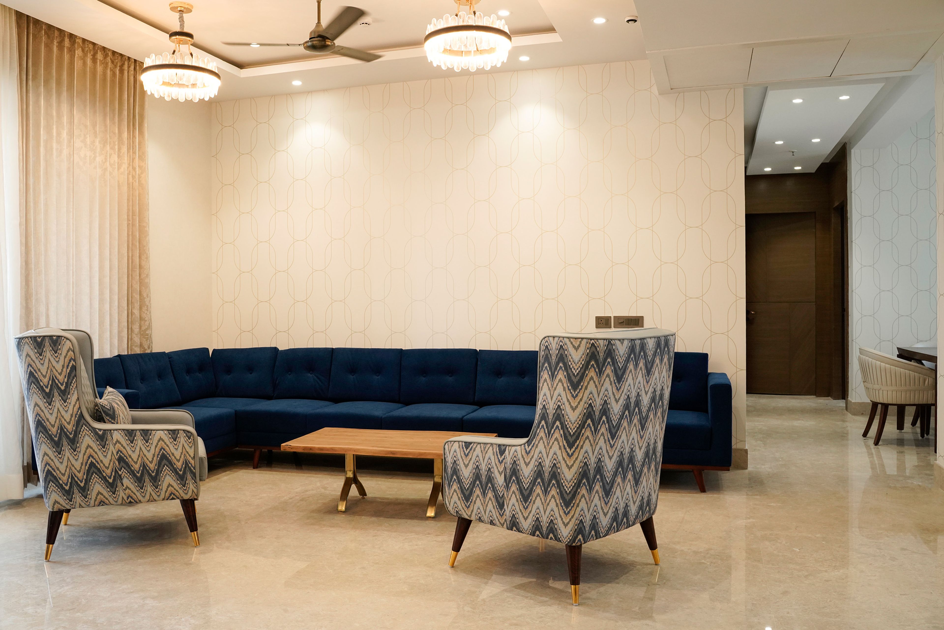 Living Room Design with Blue L-Shaped Sofa and Grey Accent Chairs