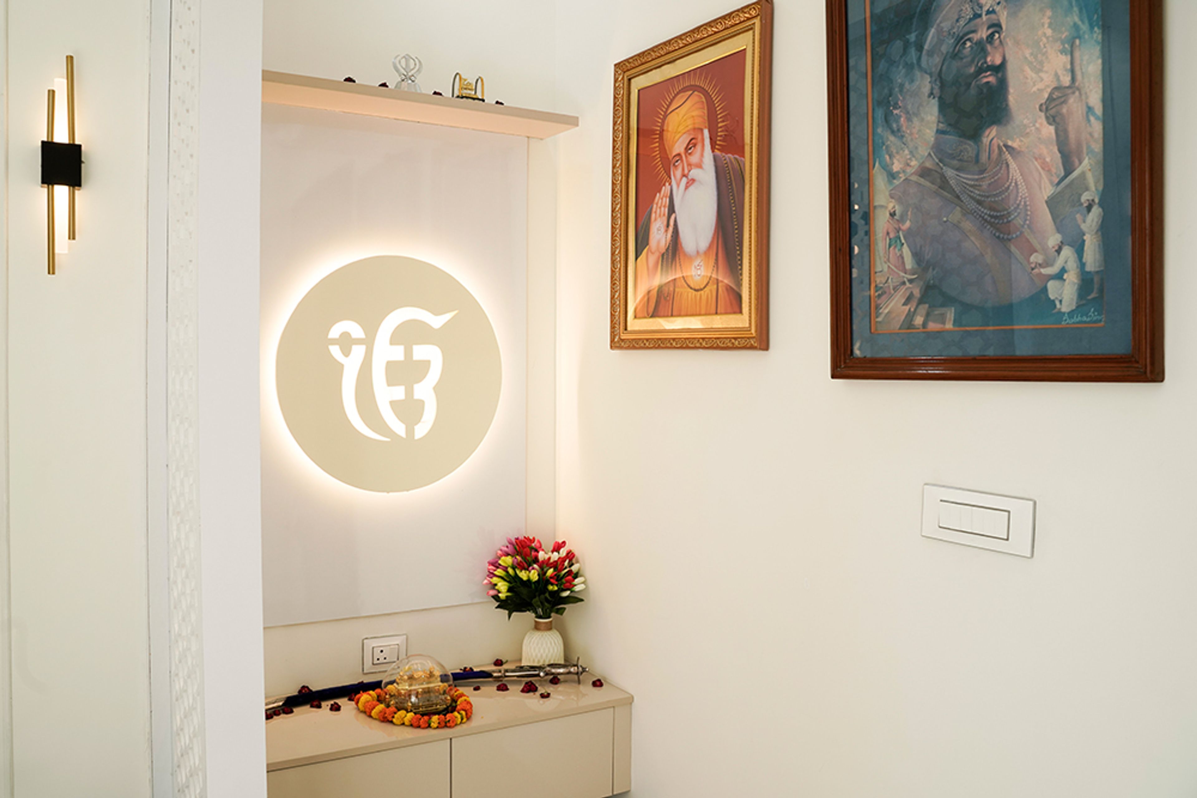 Pooja Room With Backlit Religious Symbol, Decorative Jaali Partition, Wall Art, and Floating Cabinet