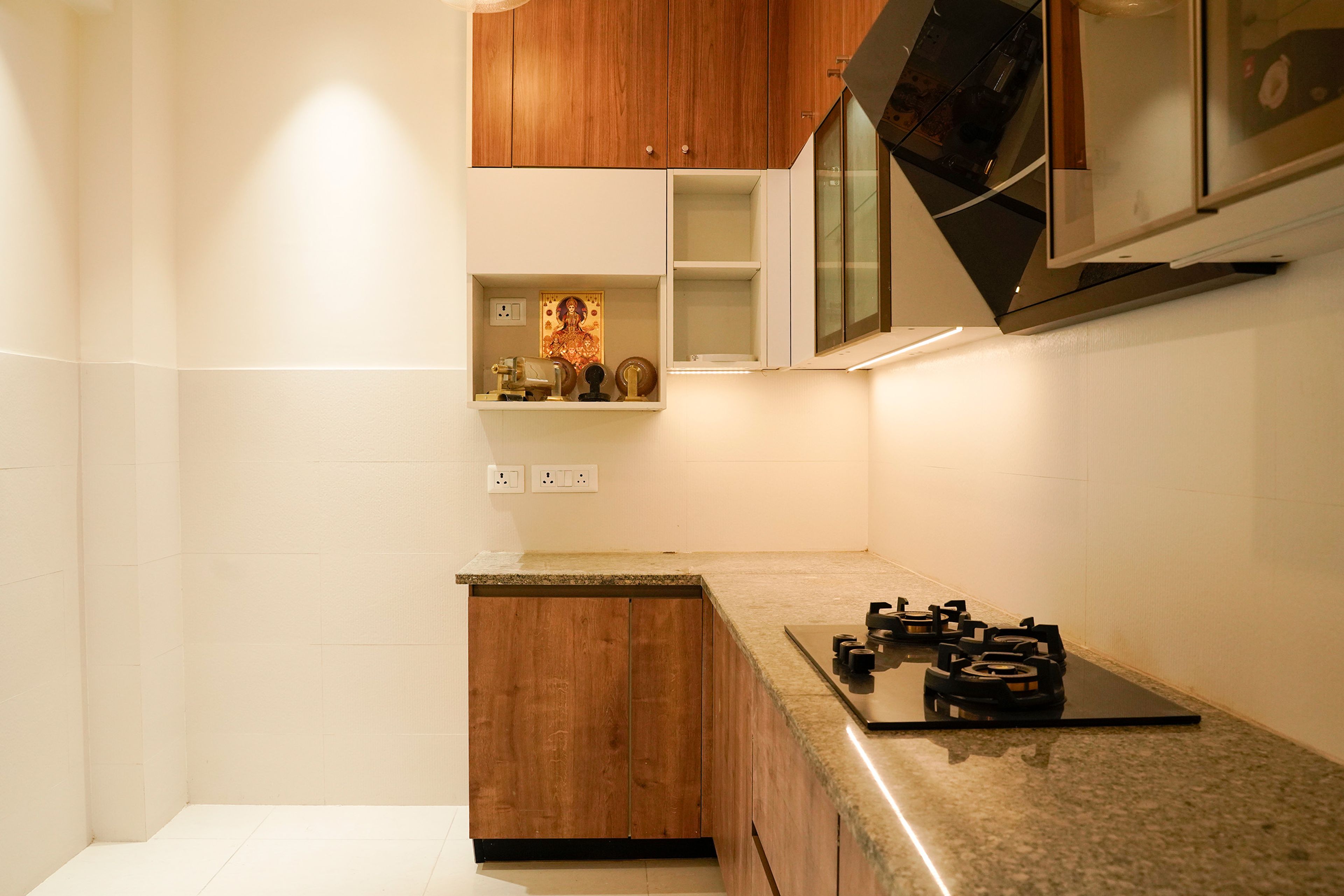 L-Shaped Kitchen Design with Granite Countertop and Pooja Shelf