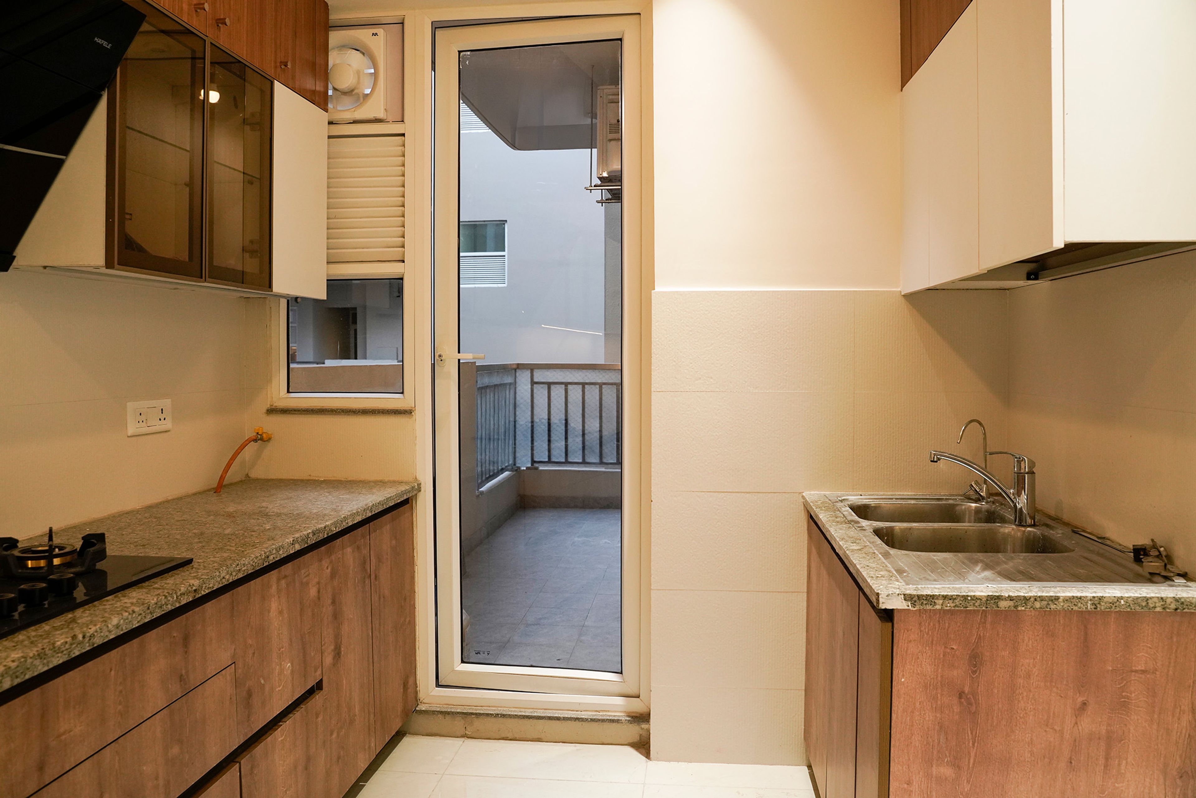 L-Shaped Kitchen Design with Granite Countertop and White Wall Units