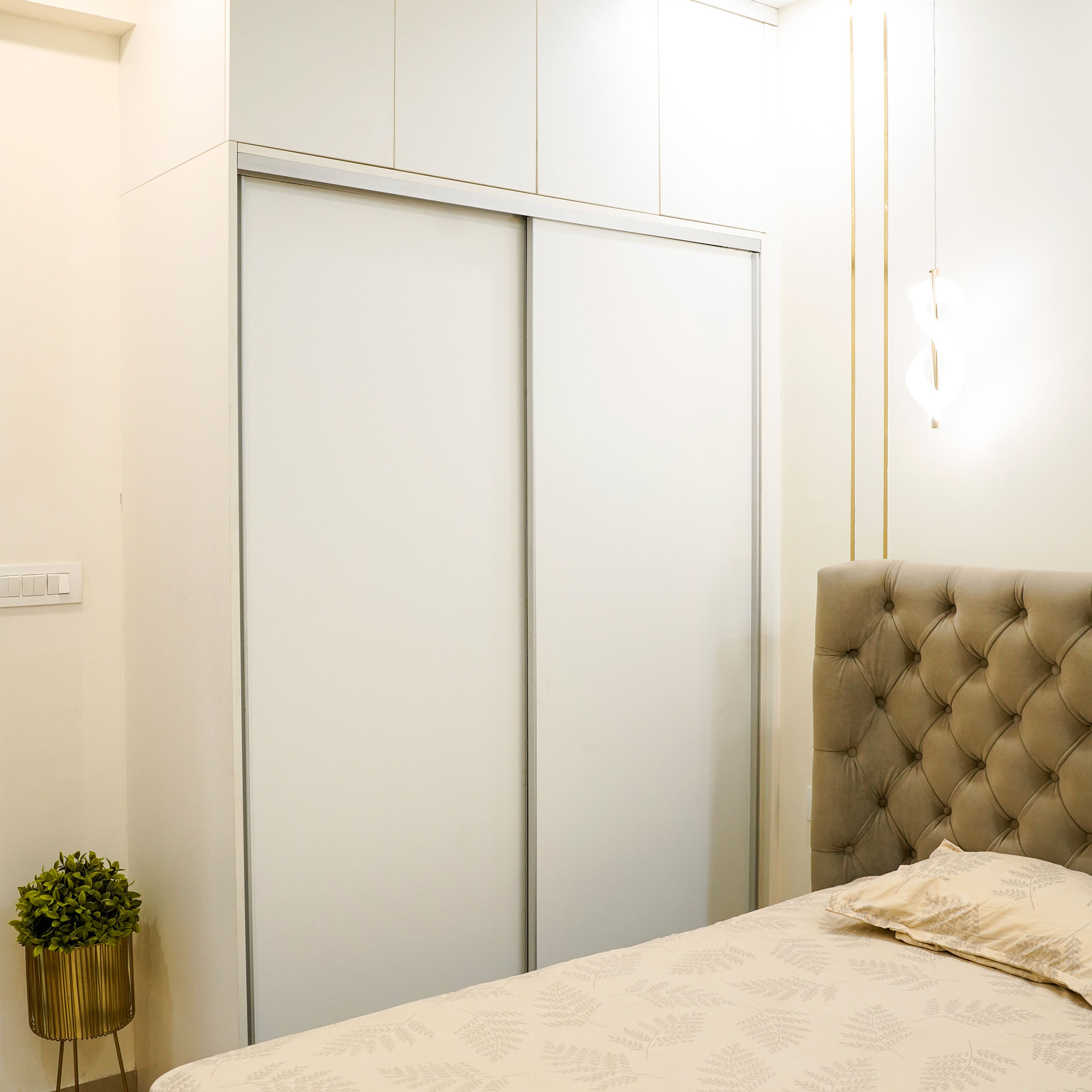 2-Door Wardrobe Design with White Sliding Doors and Upholstered Tufted Bed