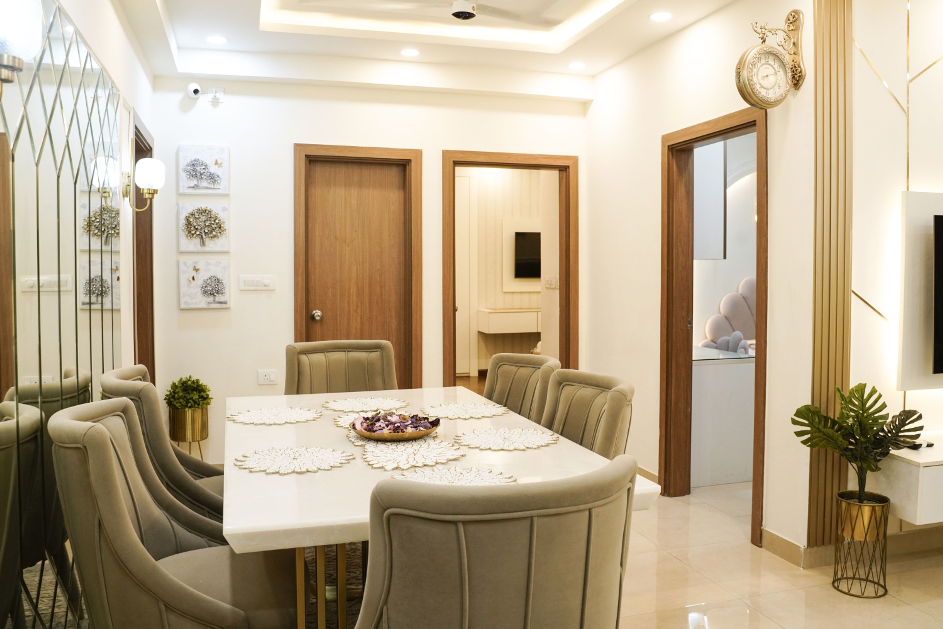Dining Room Design with Grey Upholstered Chairs, Wall Mirrors, and Wooden Doors