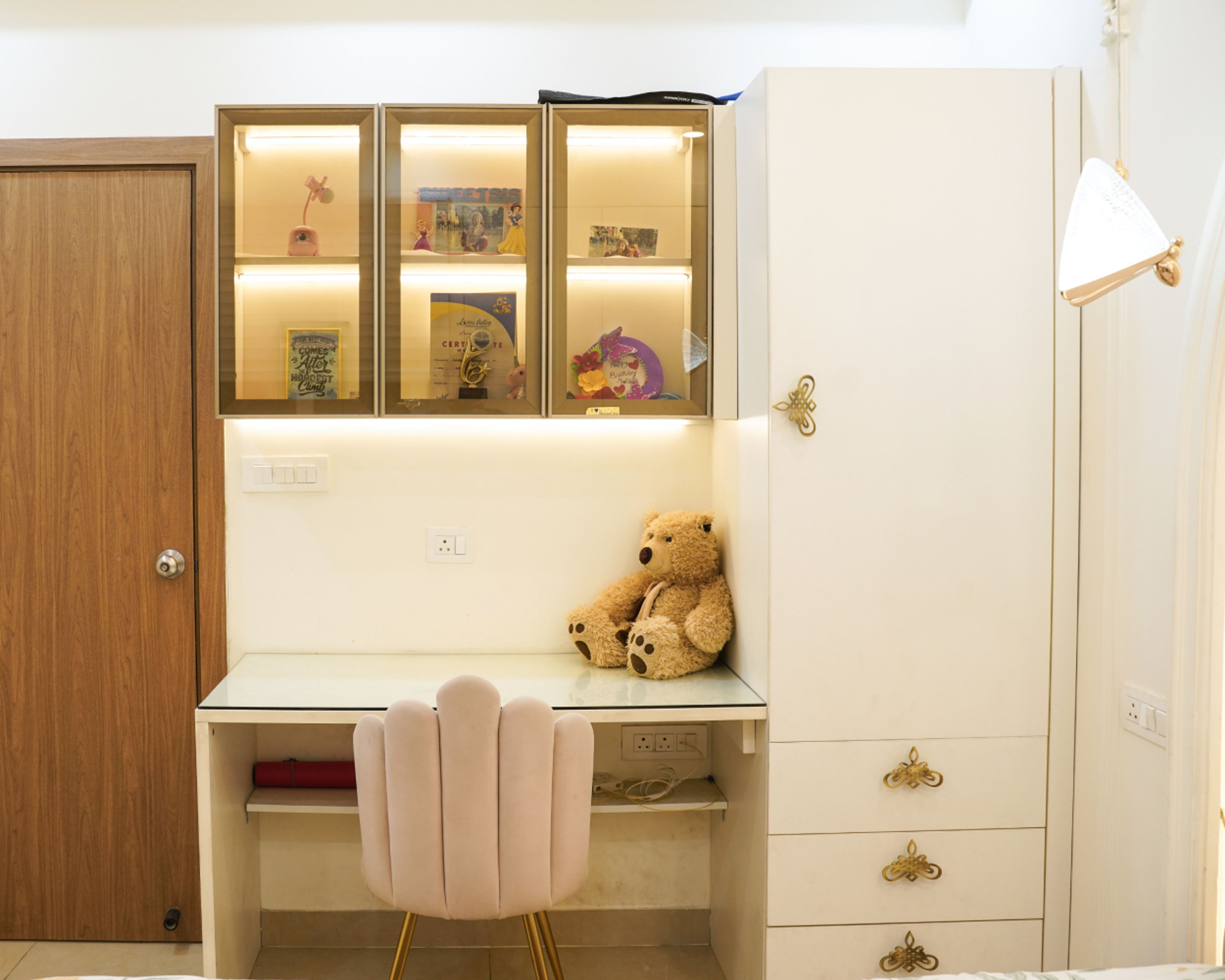 Study Unit Design with Glass Wall Cabinets, White Desk, and Plush Pink Chair