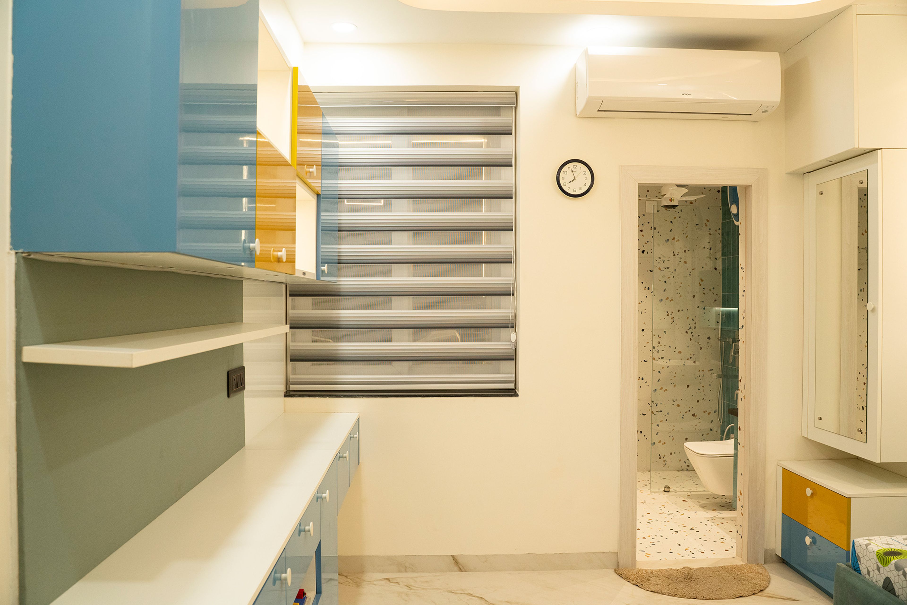 Study space with wall mounted cabinets in white, blue and yellow
