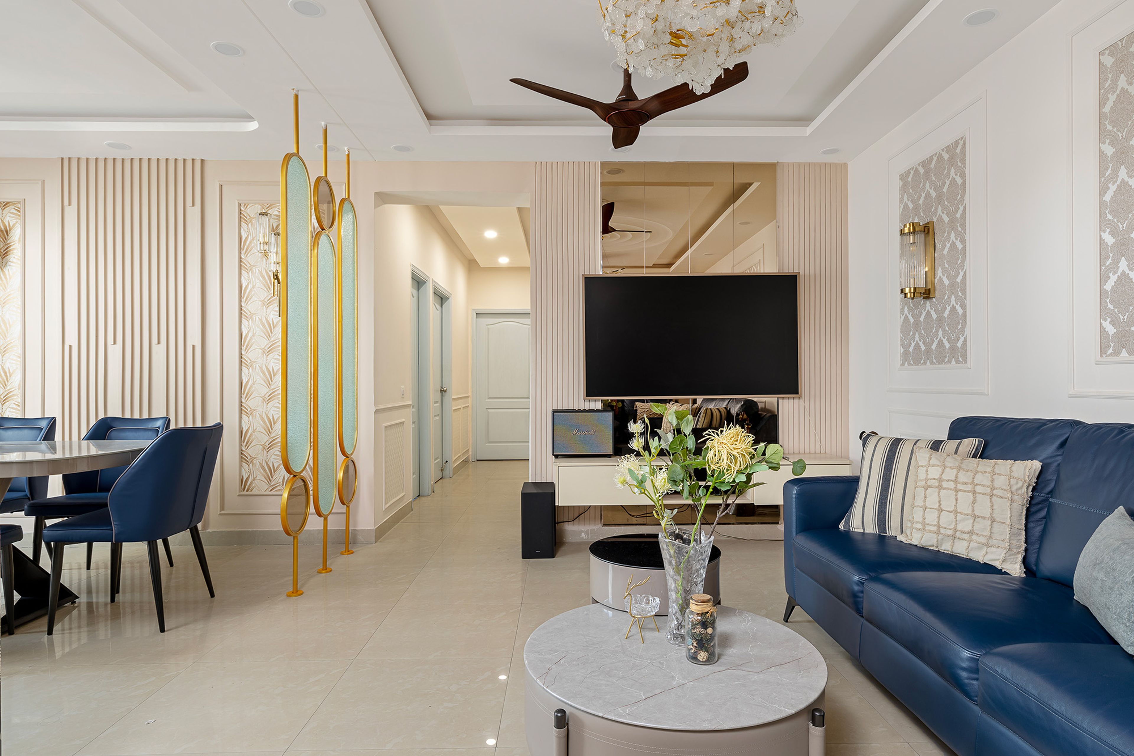 Living Cum Dining Room Design with Blue Leather Sofa and Beige TV Unit