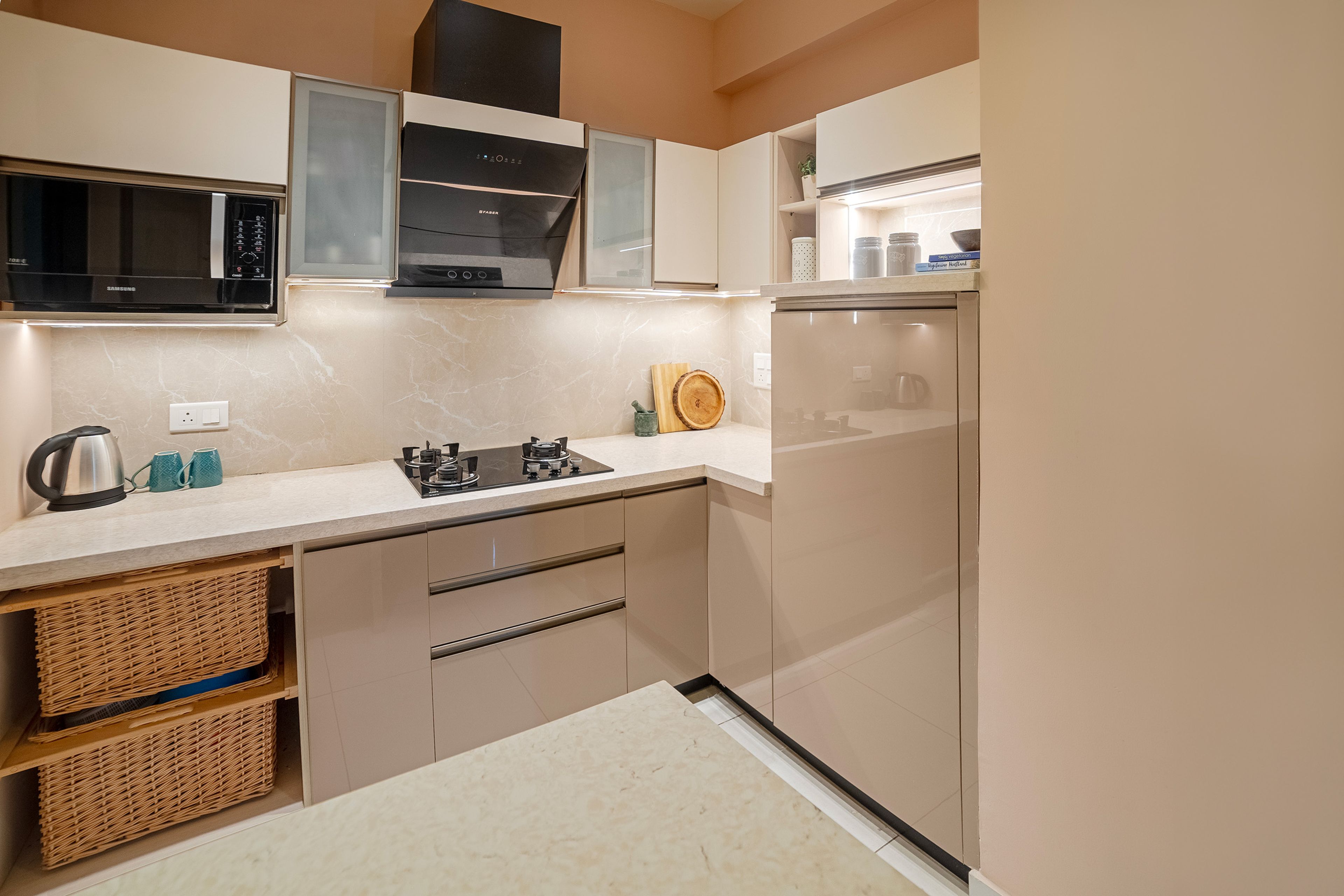 L-Shaped Kitchen Design with Light Brown Base Units, Wicker Basket and Under-Cabinet Lighting