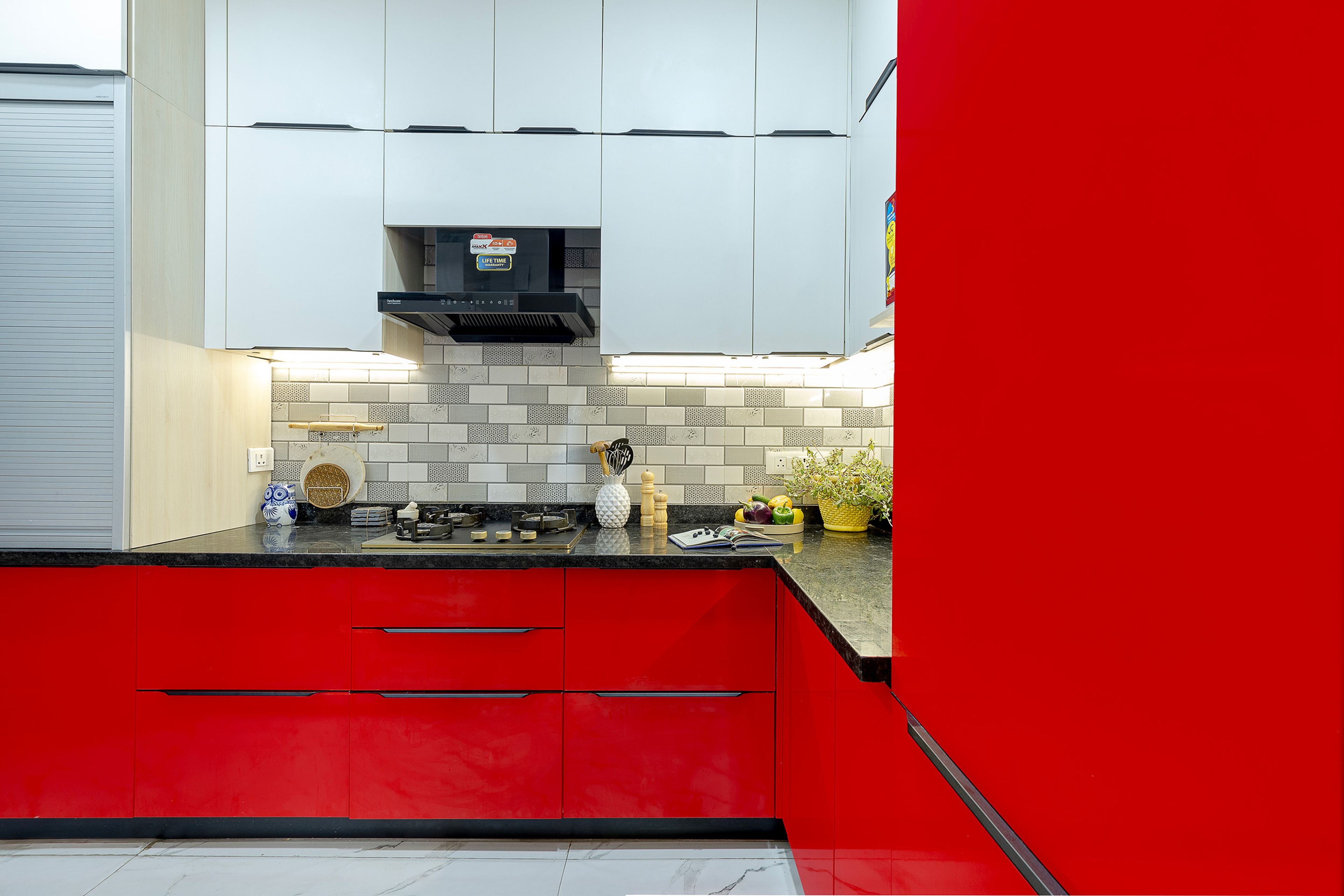 L-Shaped Kitchen Design with Red Base units and Grey Wall Units