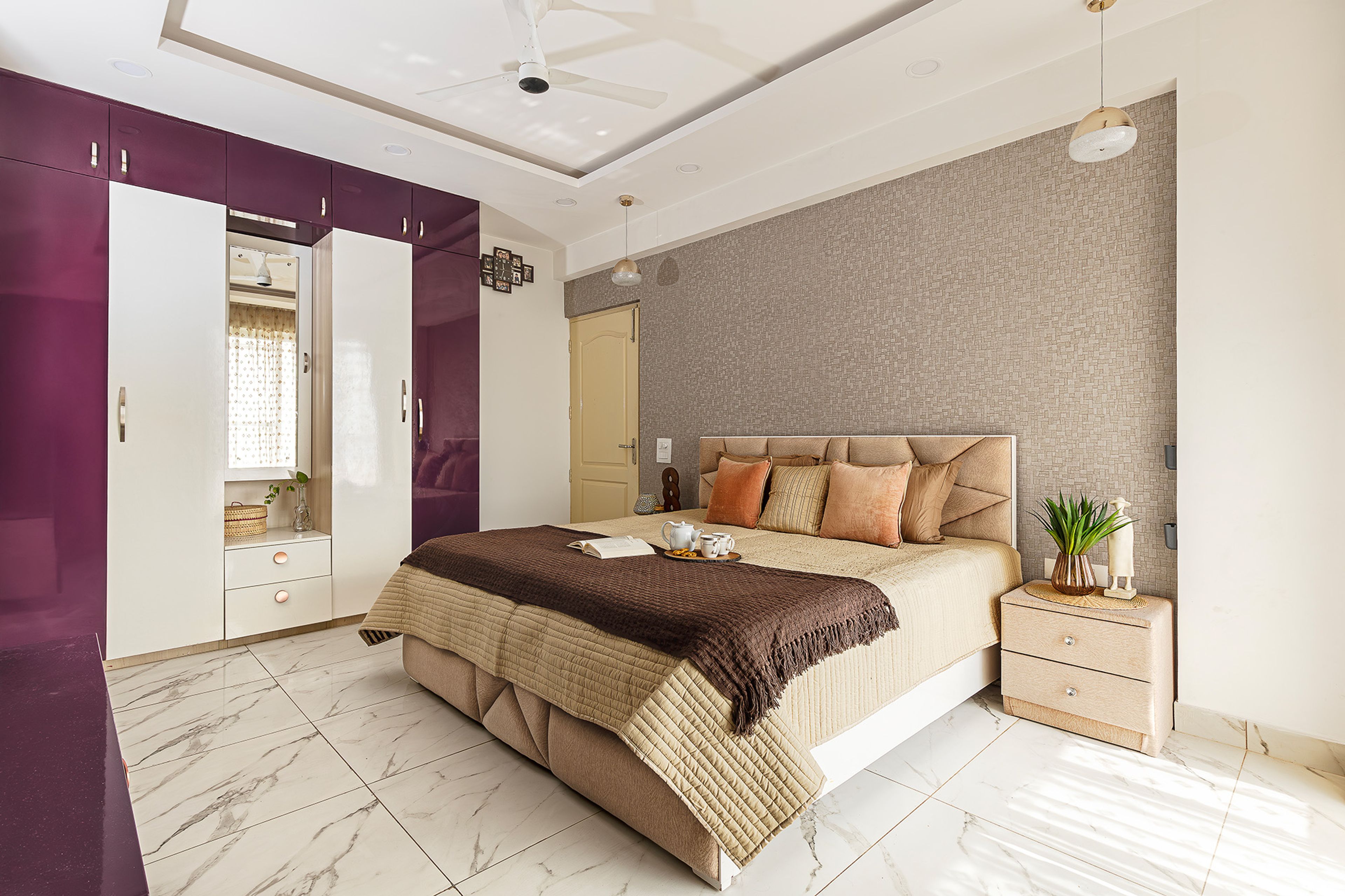 Bedroom Design with Light Brown Textured Patterned Wall and 4-Door Swing Wardrobe with Dressing Unit