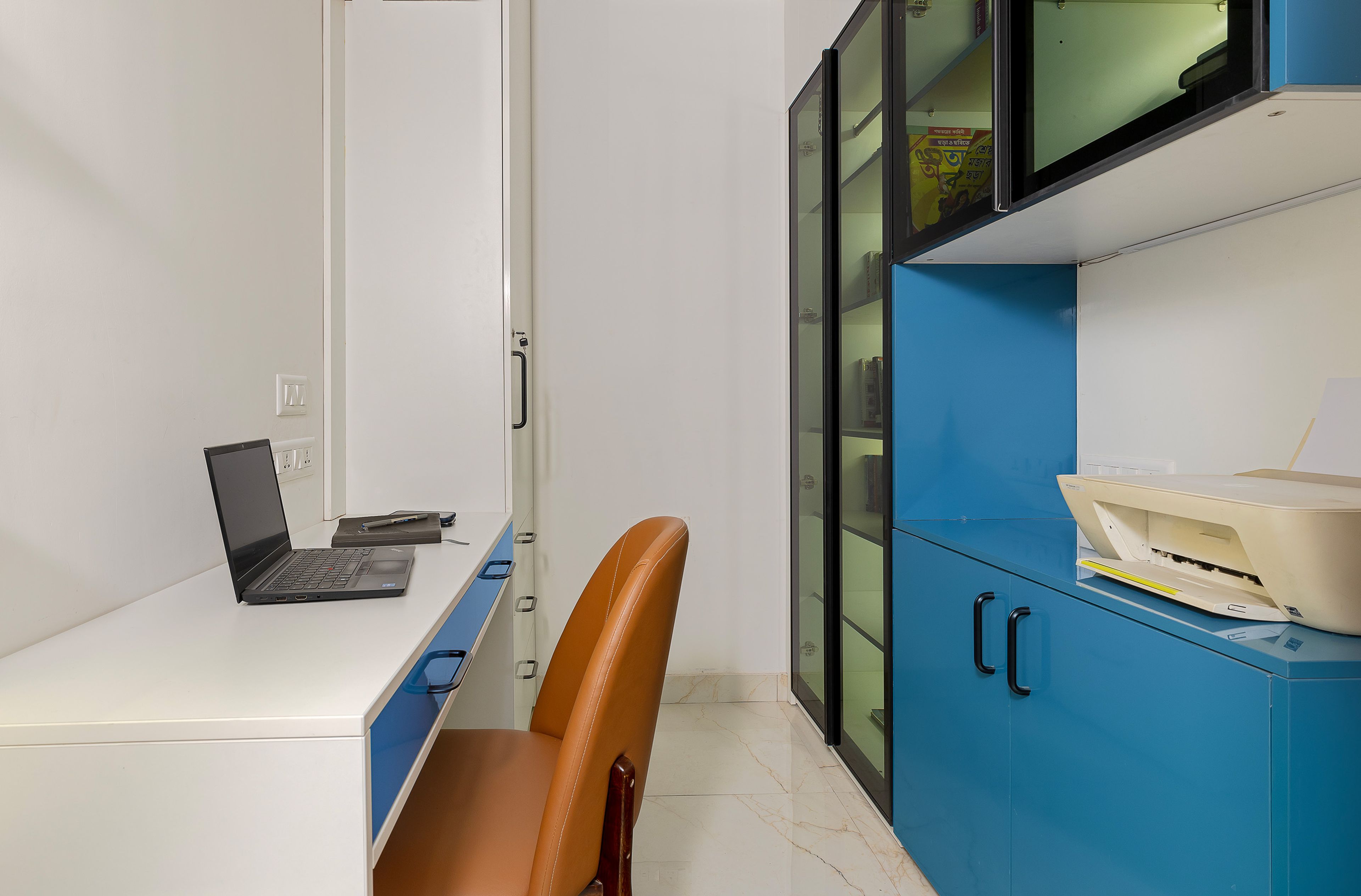 Home Office Design with White and Blue Desk, Brown Chair and Blue and Glass Shutter Wall Mounted Storage Units