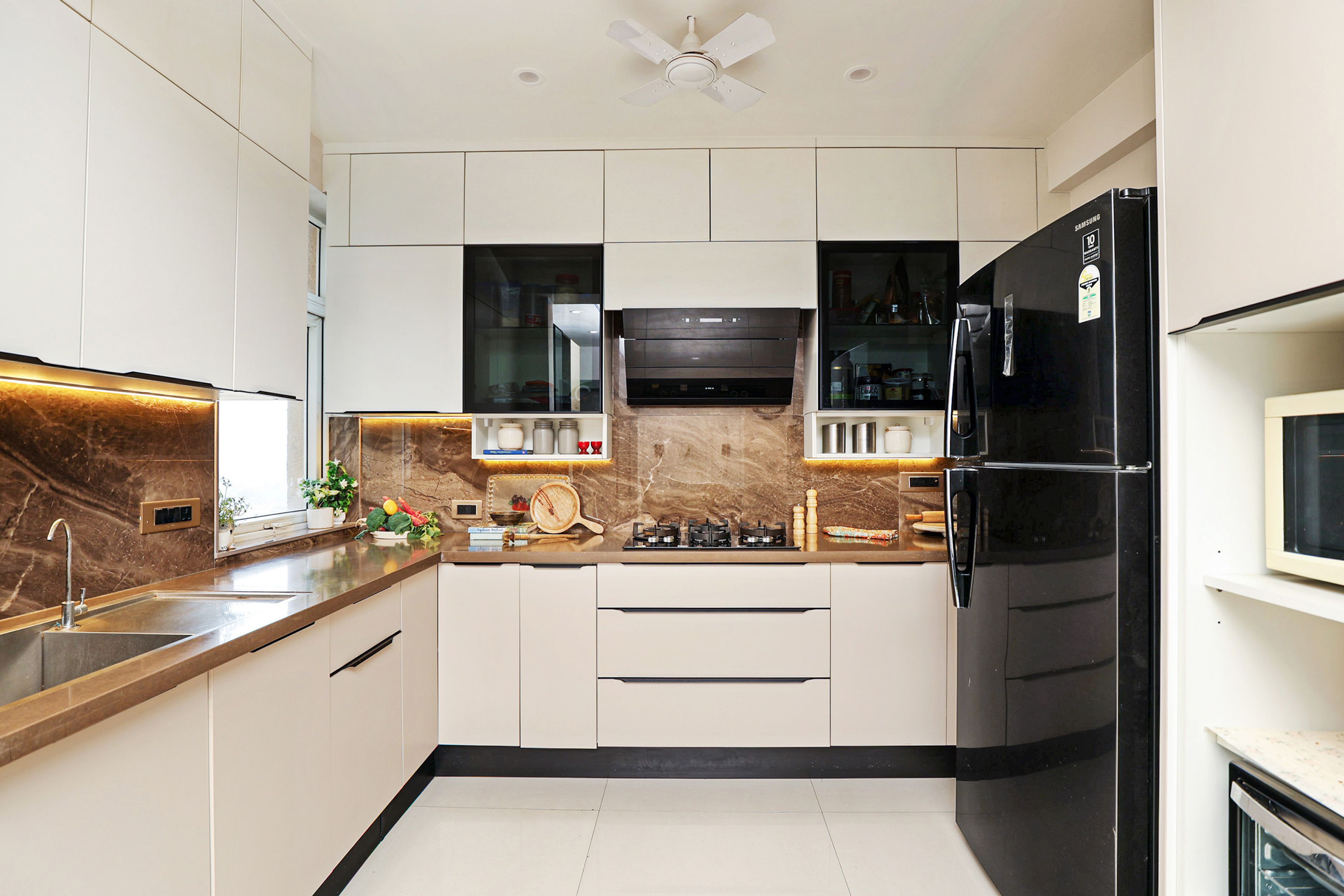 U-Shaped Kitchen Design with Cream Units and Brown Granite Countertop
