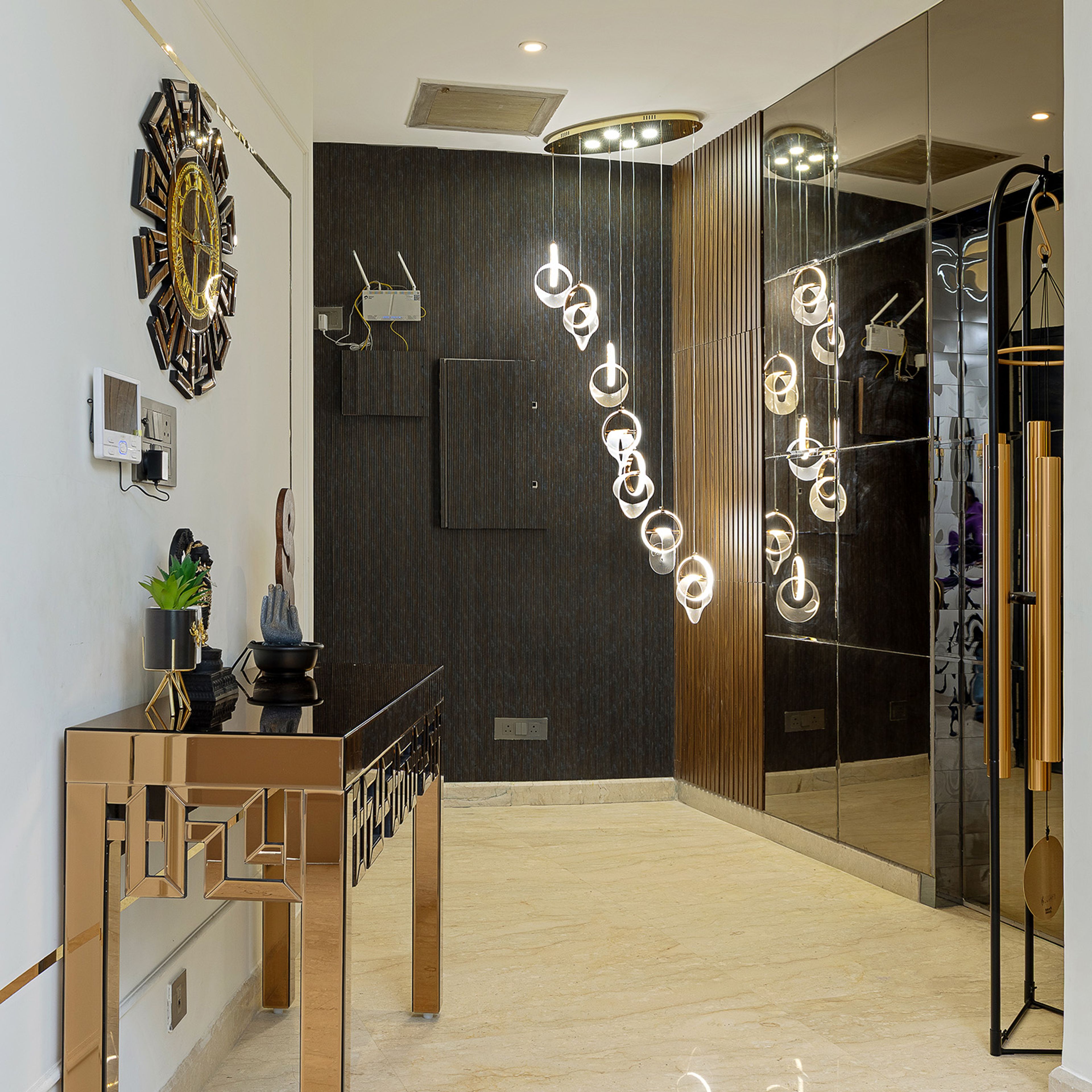Foyer Design with Metal Table, Chandelier and Black Wall with Louvers