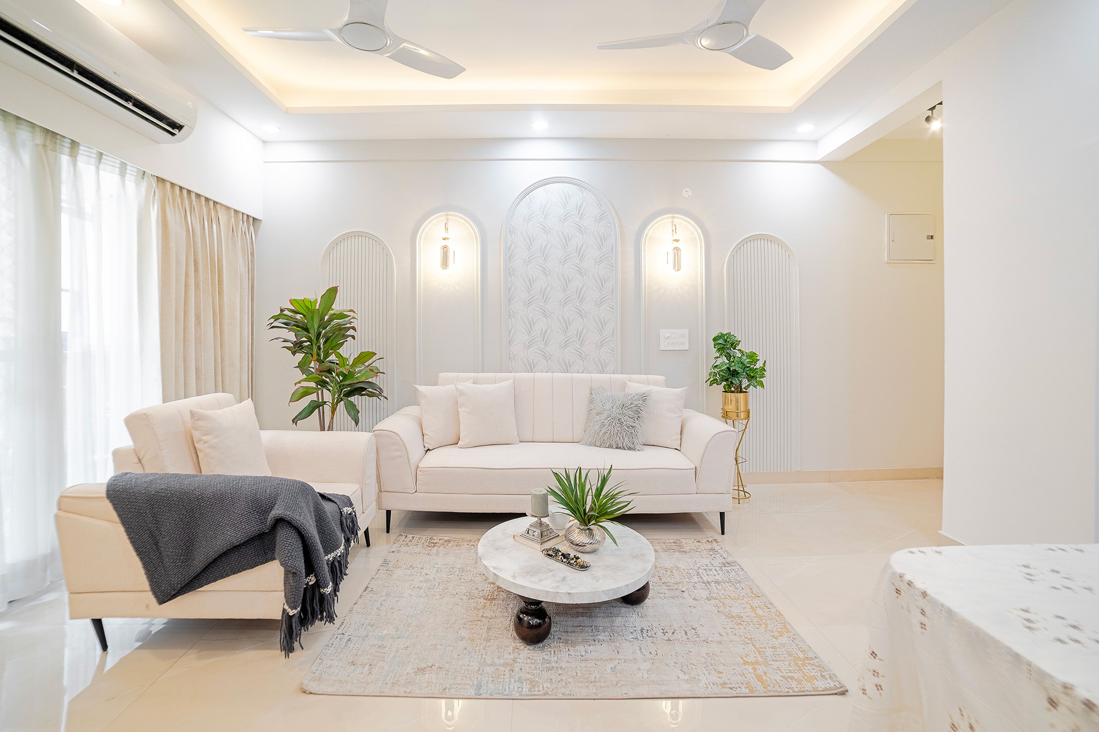 Living Room Design with Off-White Sofa, False Ceiling and White Walls with Arched Trims