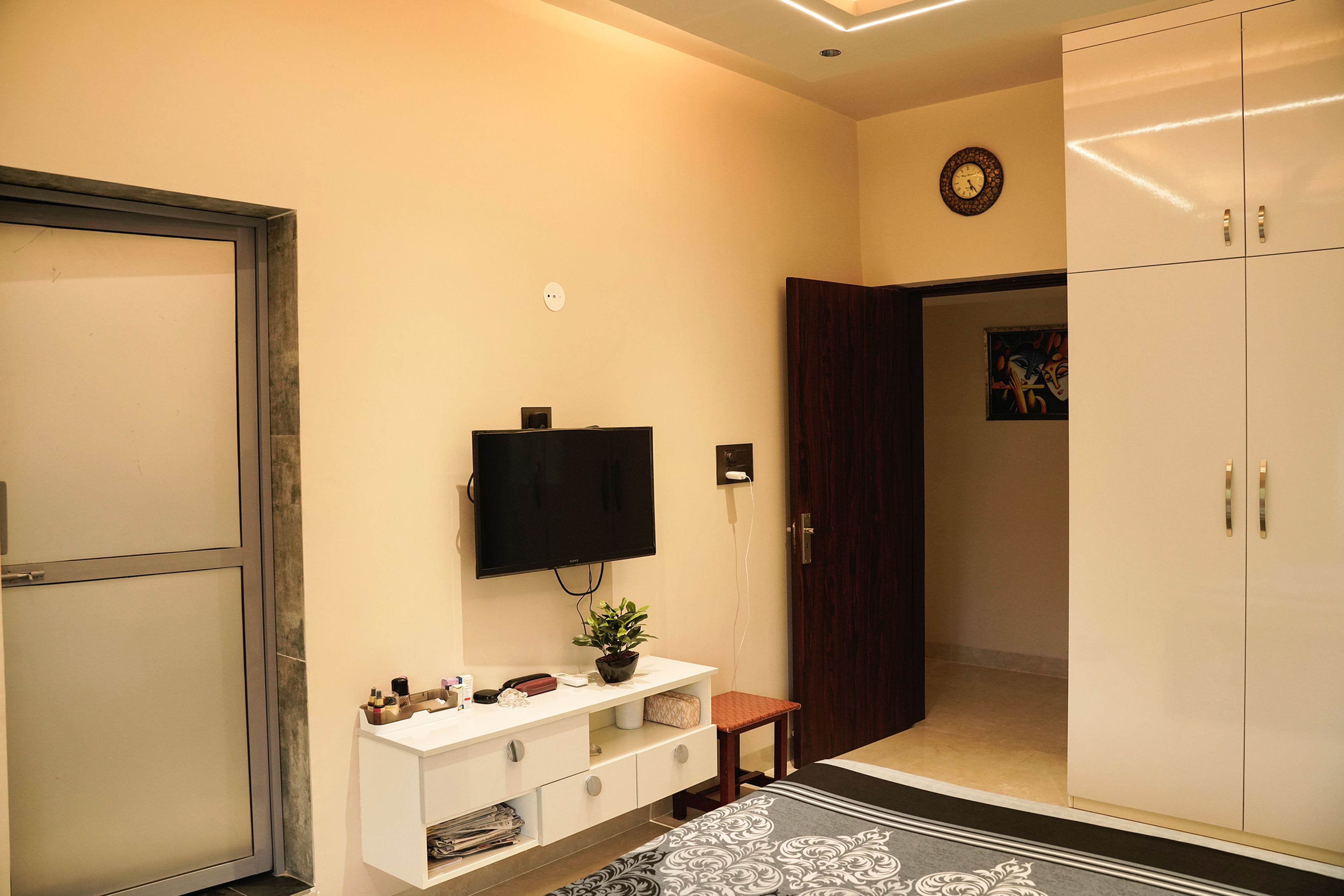 Bedroom design with TV Unit and cream wardrobe
