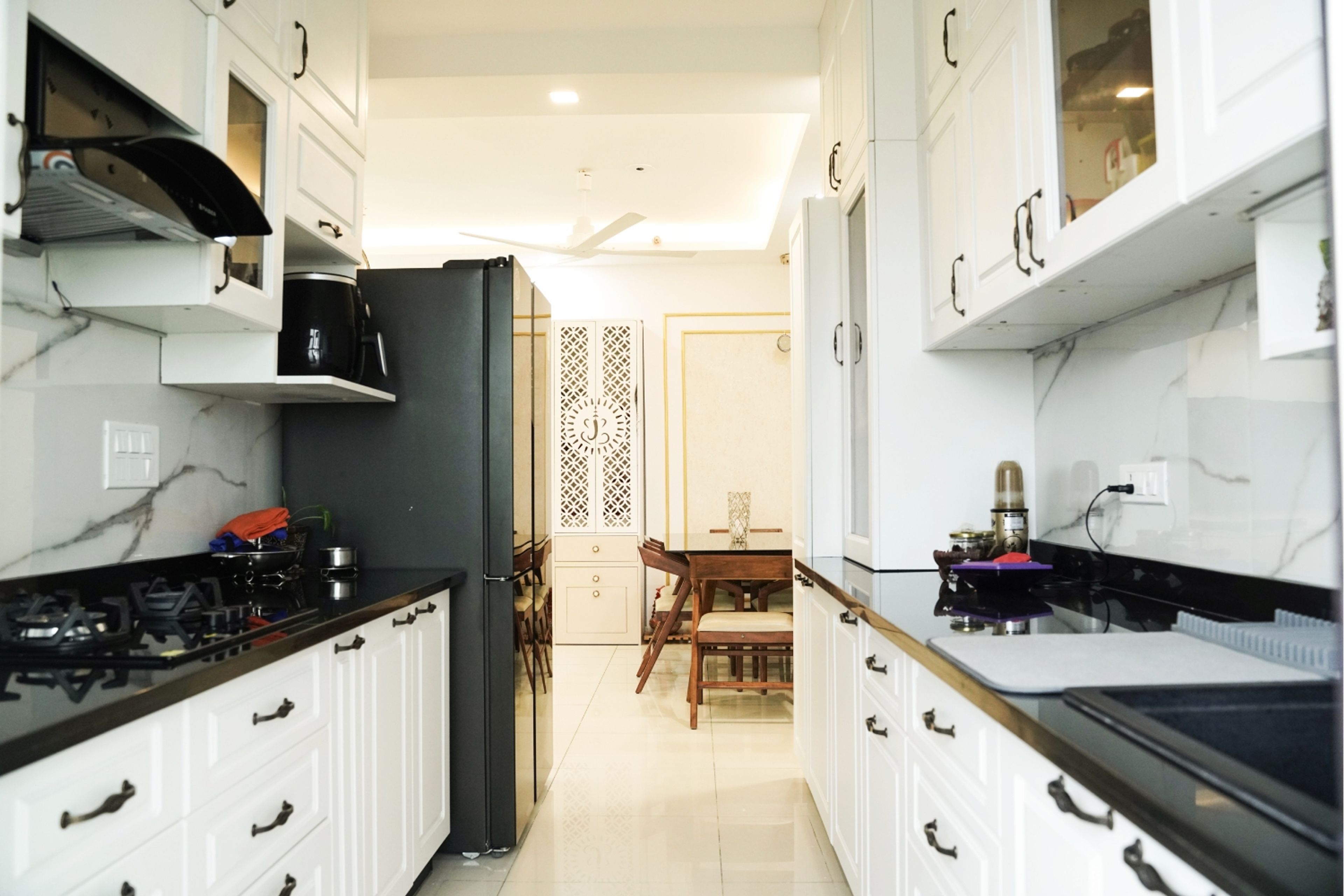 Parallel Kitchen Design with White Profile Shutter Units and Granite Countertop