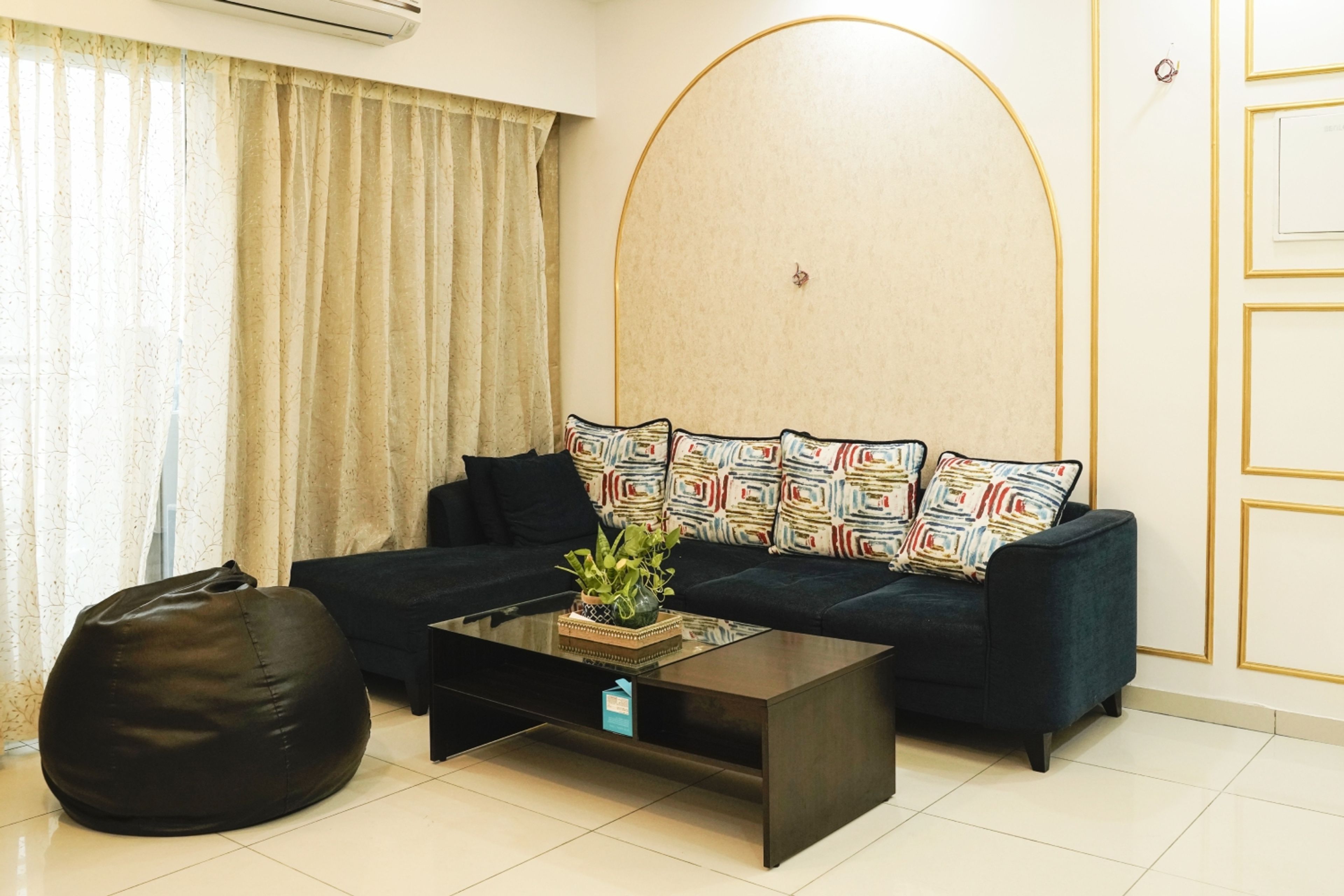 Living Room Design with Navy Blue L-Shaped Sofa, Bean Bag and Arch Design Wall
