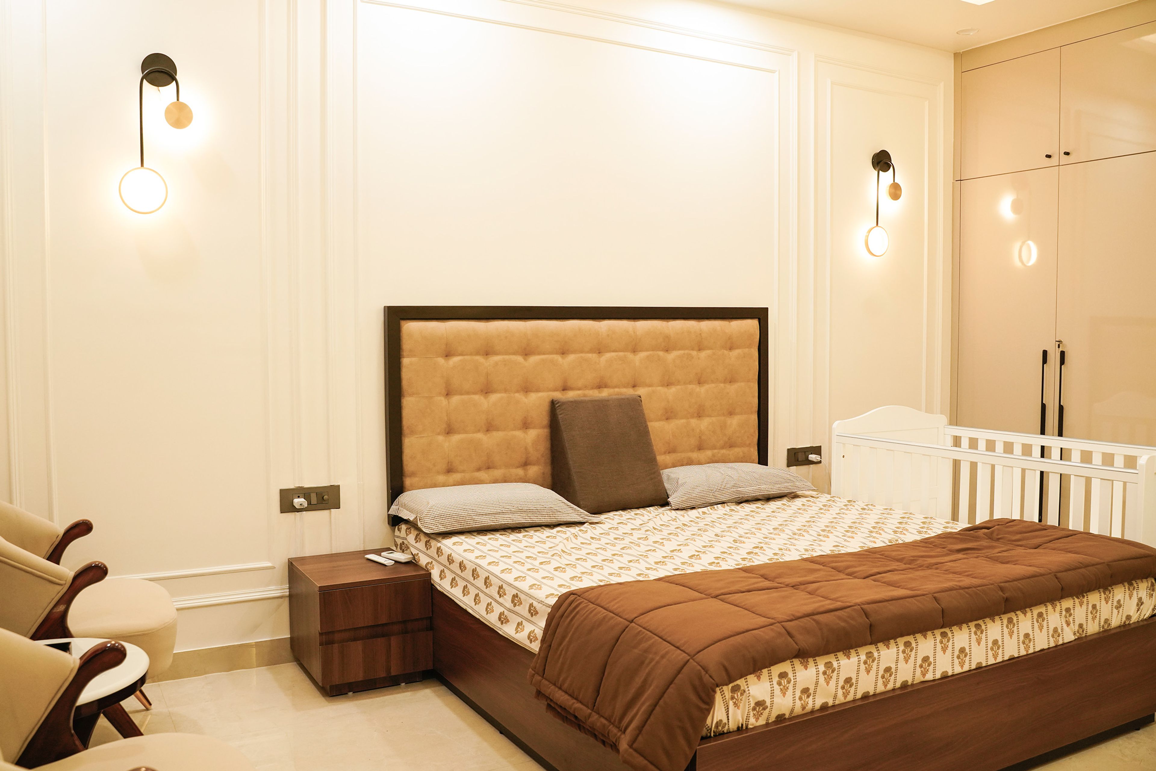 Master Bedroom Design with Upholstered Headboard, Wall Sconces, and Wooden Bed with Side Tables