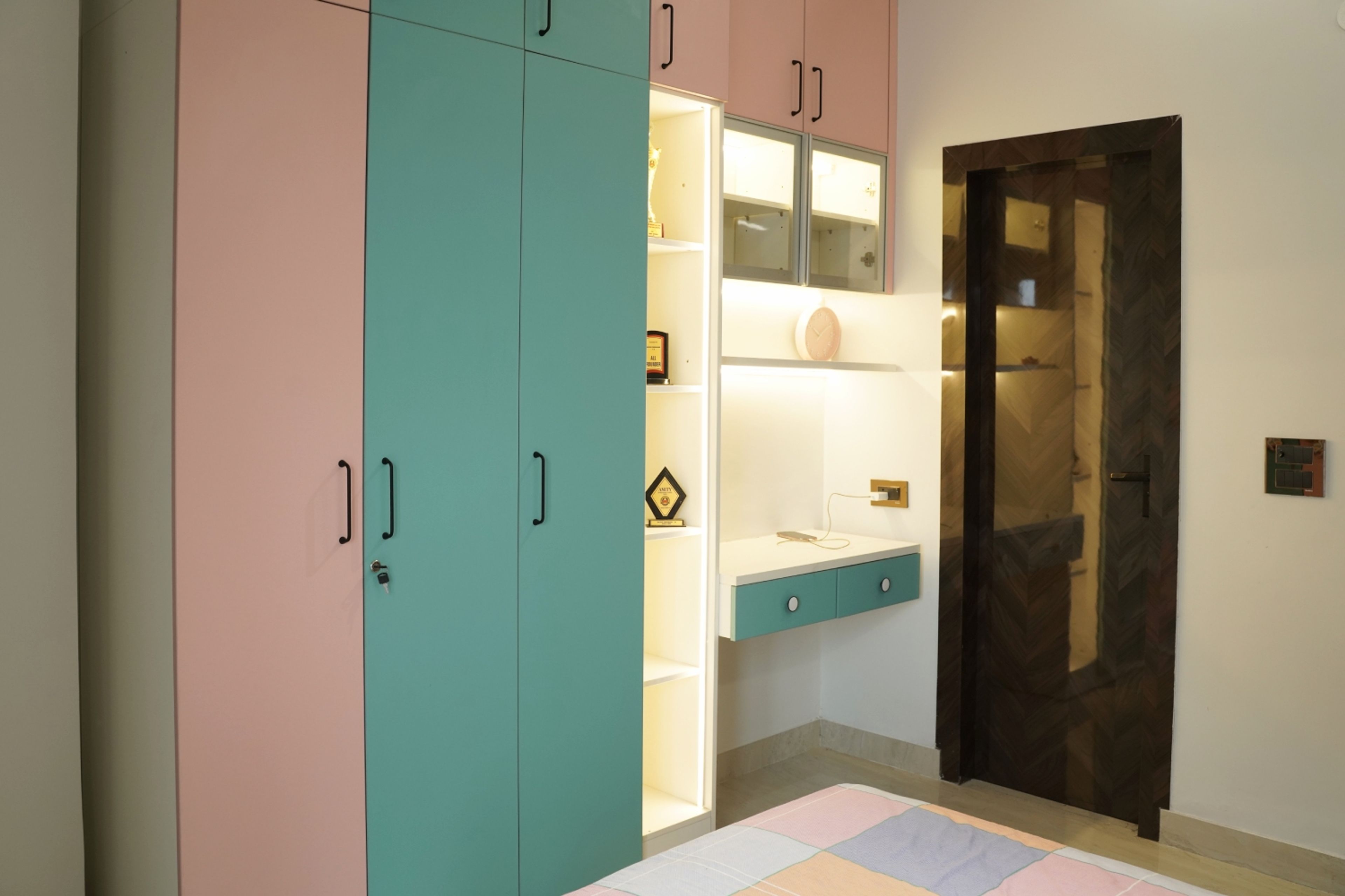 3-door pink and green swing wardrobe design and study space