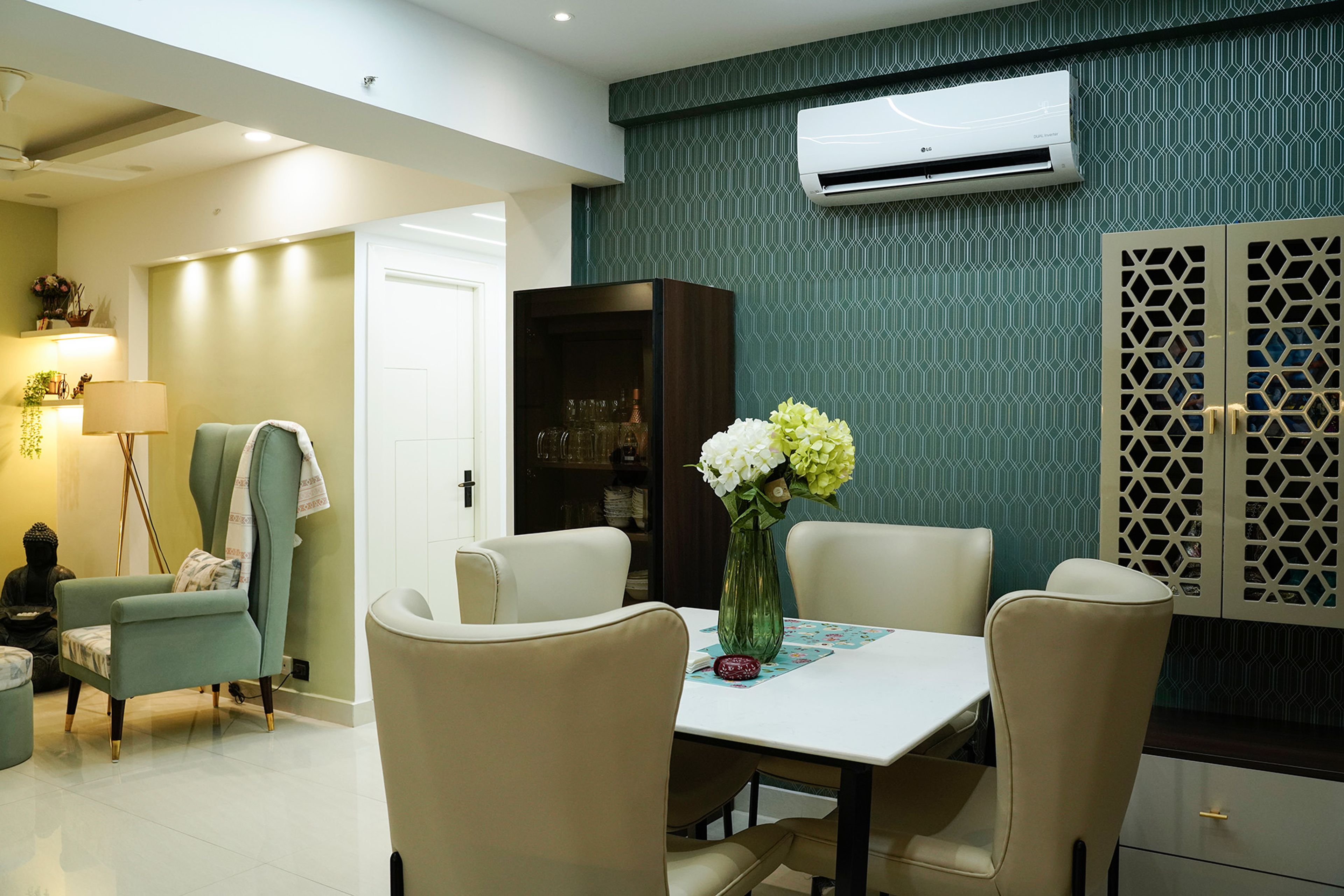 Dining Room Design with Cream Chairs, Teal Geometric Wallpaper, and Wall-Mounted Cabinets