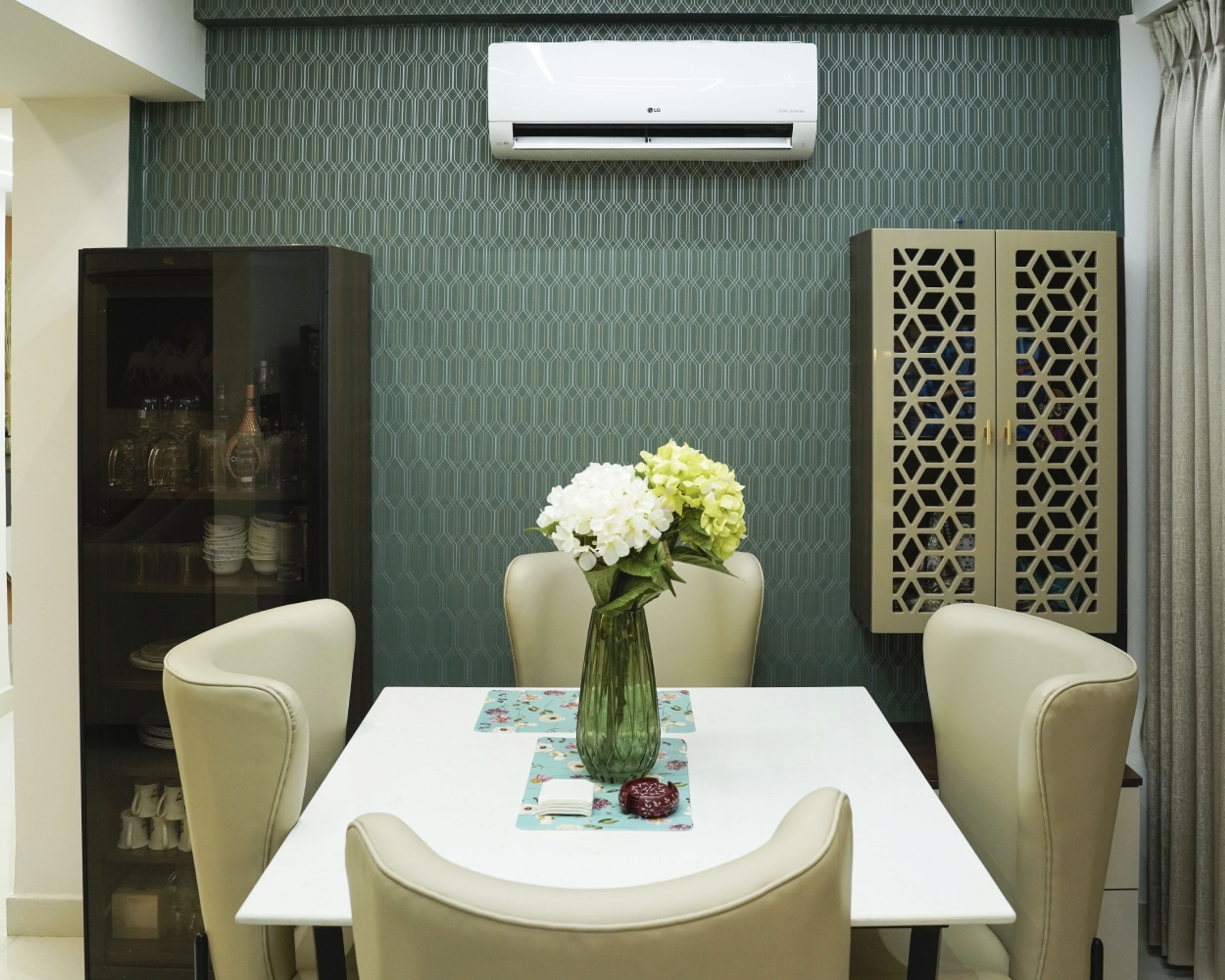 Dining Room Design with Cream Chairs, Teal Geometric Wallpaper, and Wall-Mounted Storage Cabinets