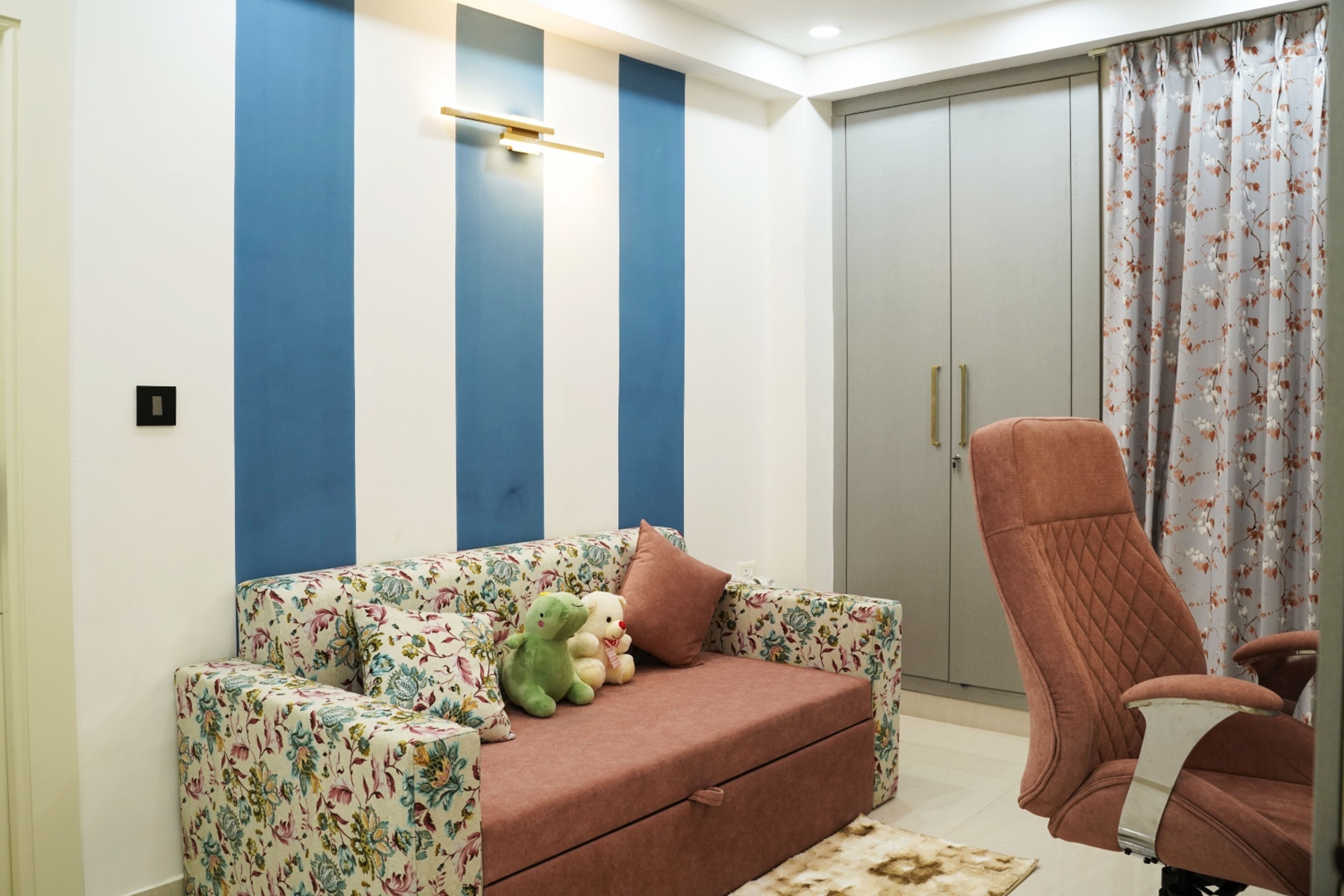 Kids Bedroom Design with Floral Sofa, Blue Striped Wall Paint, and Grey Wardrobe