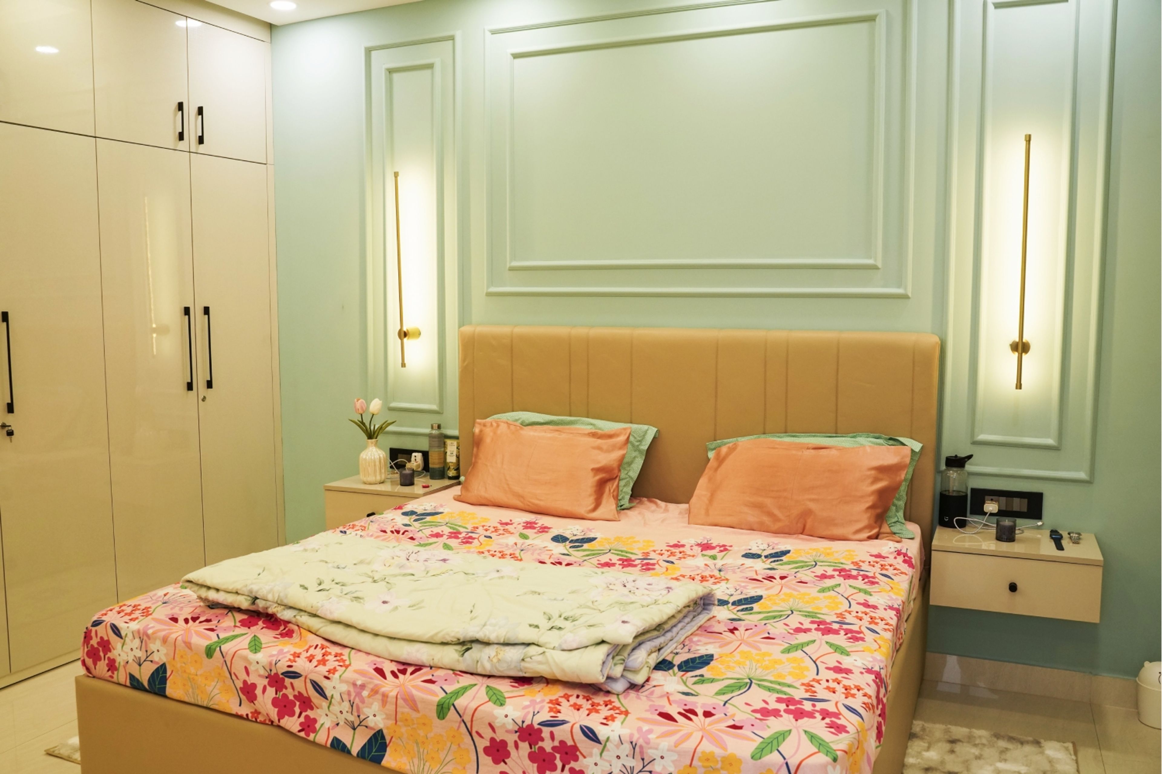 Master Bedroom Design with Mint Green Wall Panels, Beige Upholstered Bed, and Glossy Wardrobe