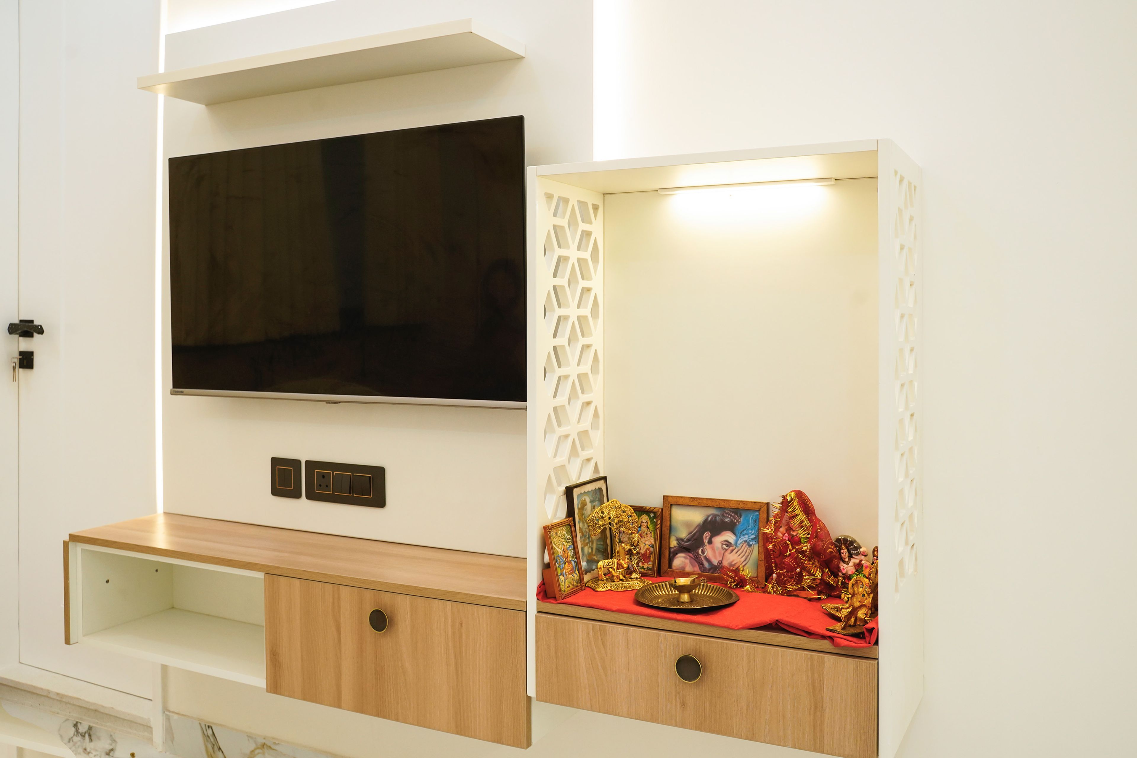 Wall-Mounted TV Unit Design with Wooden Drawers and Integrated Pooja Unit