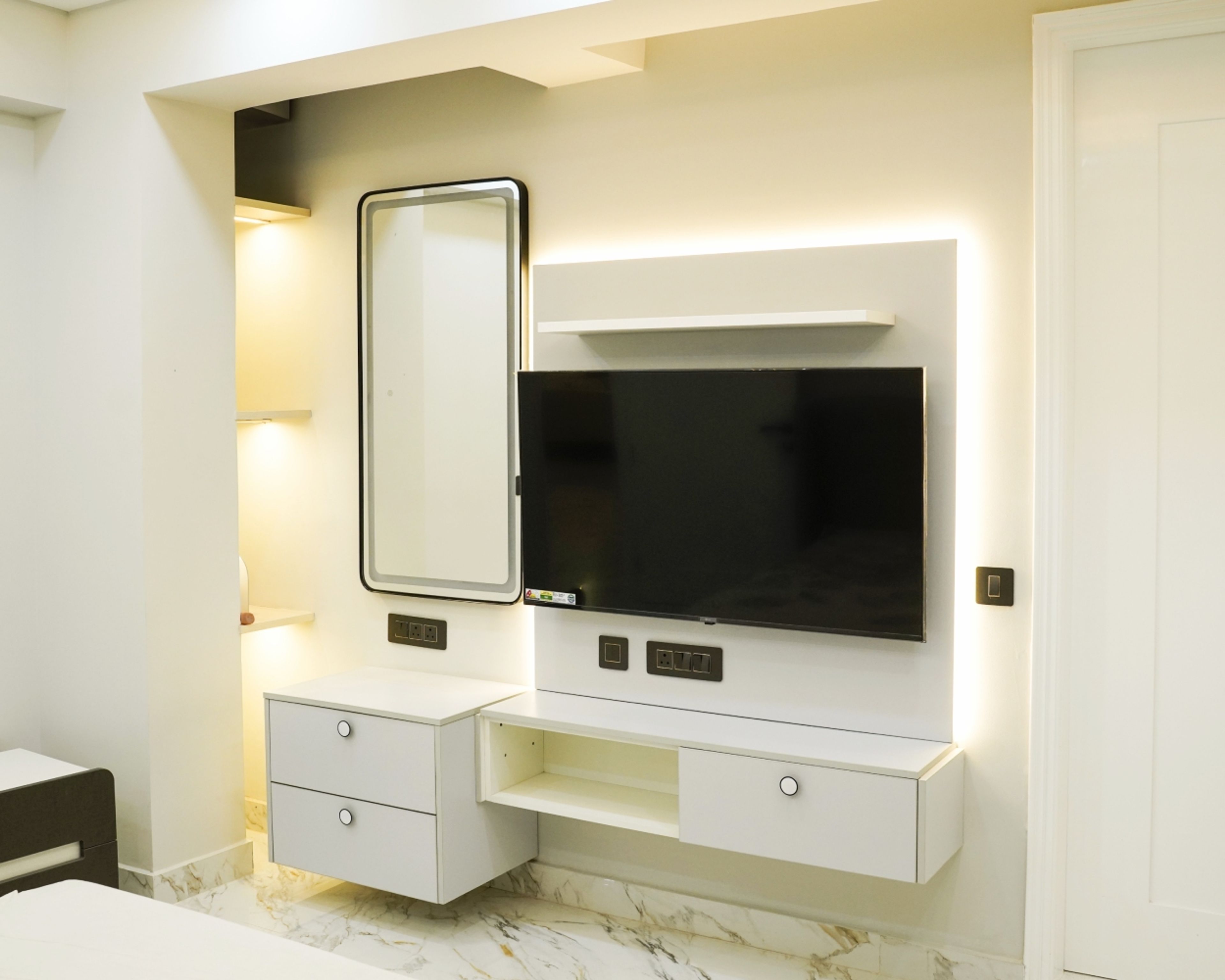 TV Unit Design with White Floating Drawers, Backlit Panel, and Wall Mirror