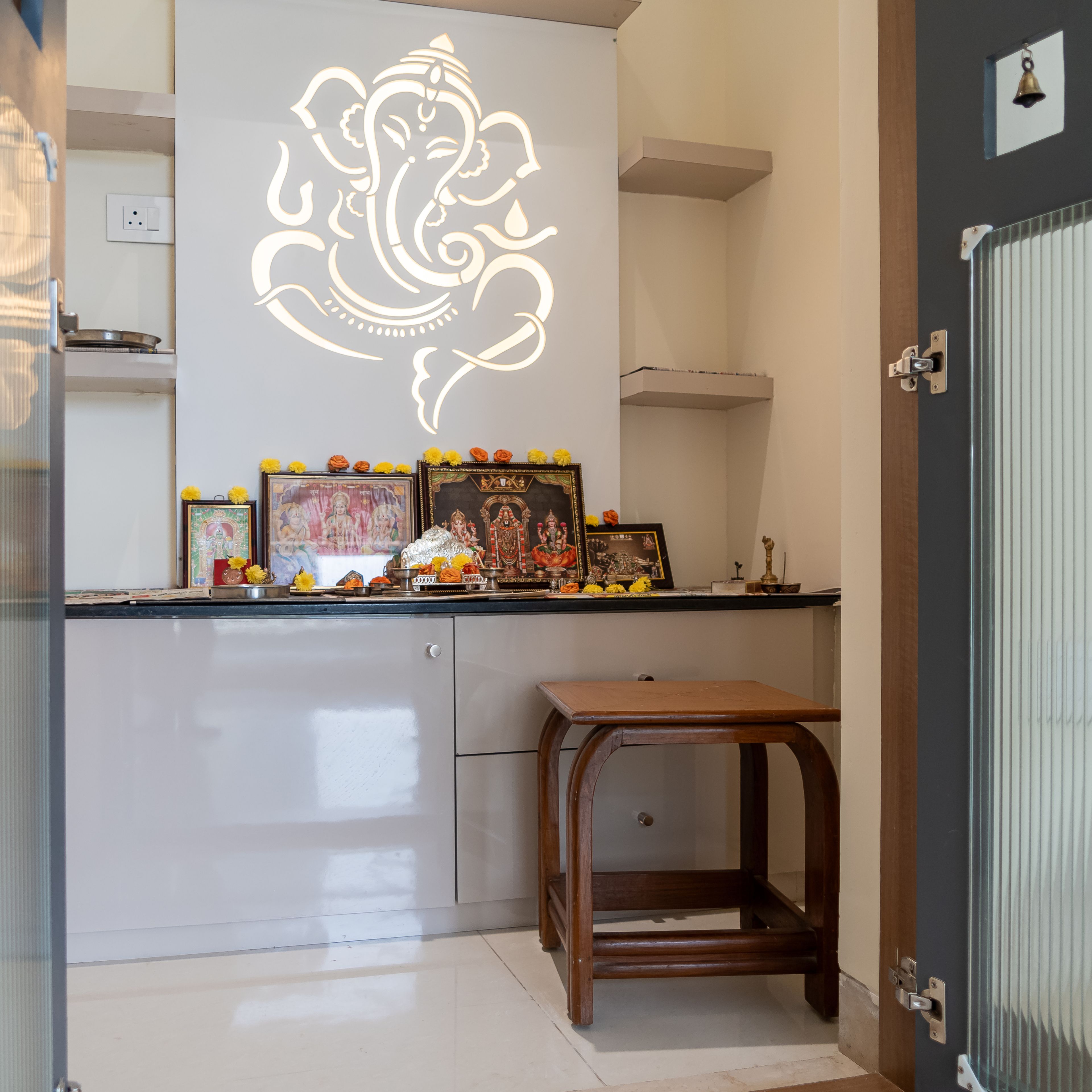 Pooja Room Design with White CNC Cut Ganesha Panel and Marble Countertop