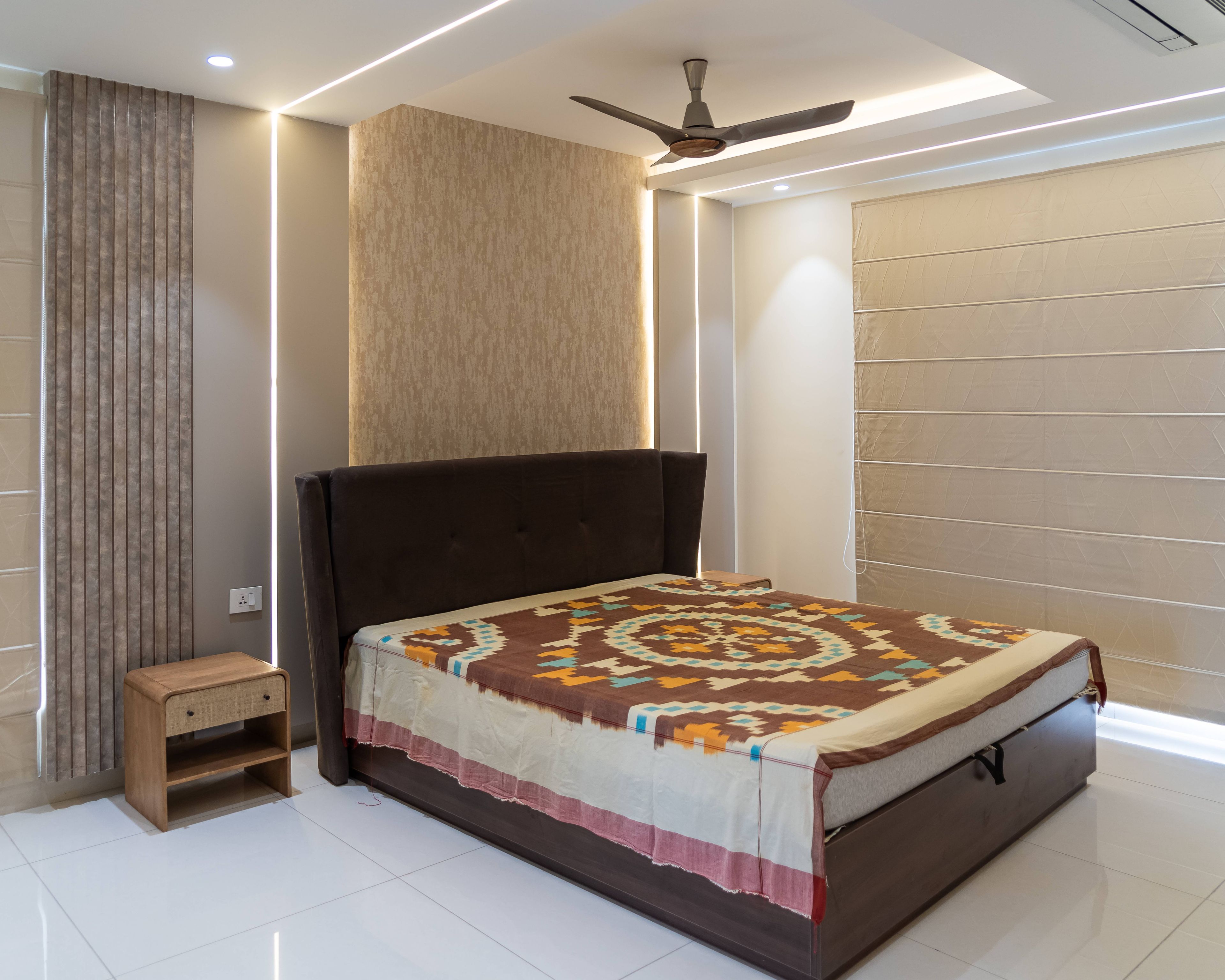 Master Bedroom Design with Brown Bed, Textured Beige Wallpaper, and Ceiling Cove Lights