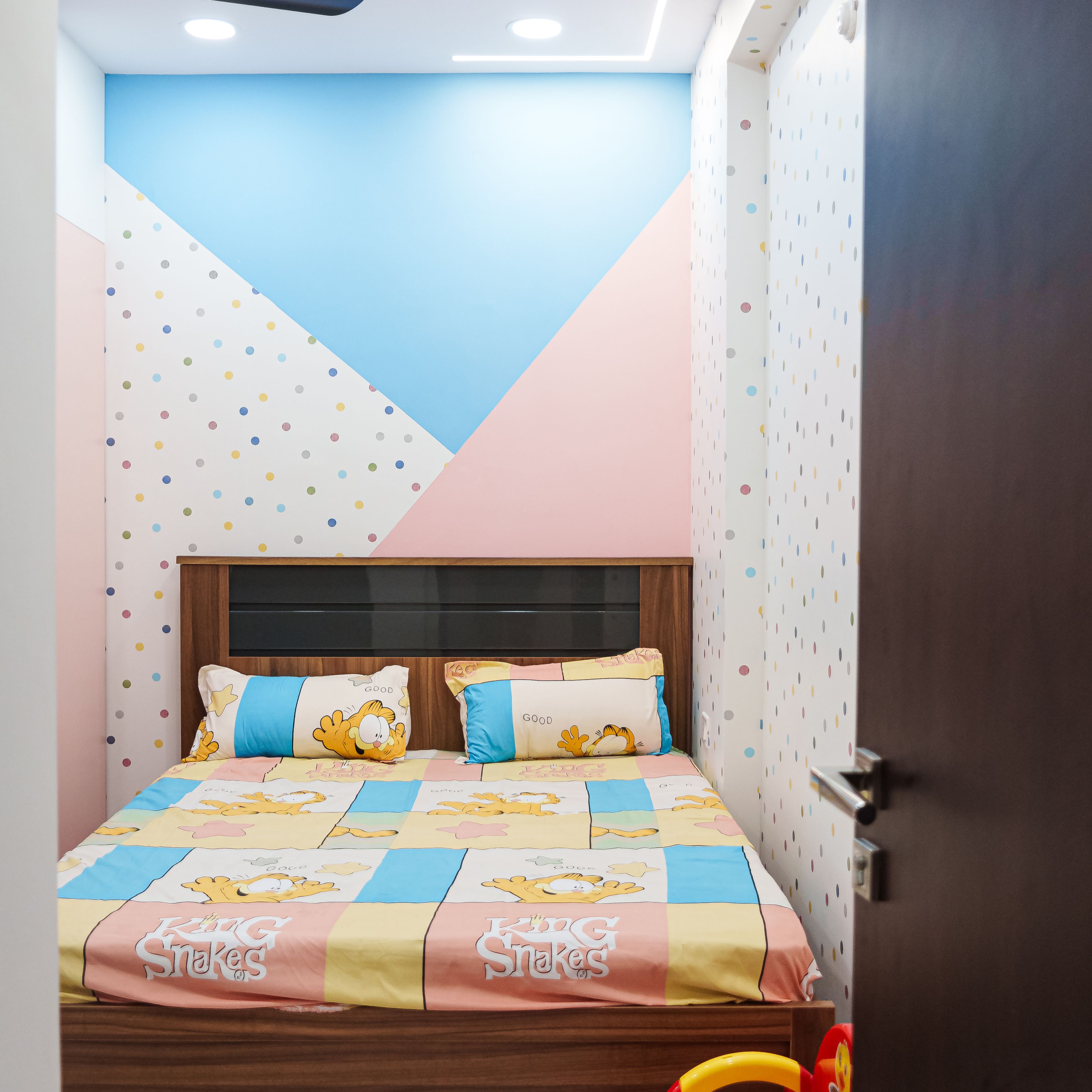 Kids Bedroom Design with Colorful Geometric Wall Paint and Polka Dot Wallpaper
