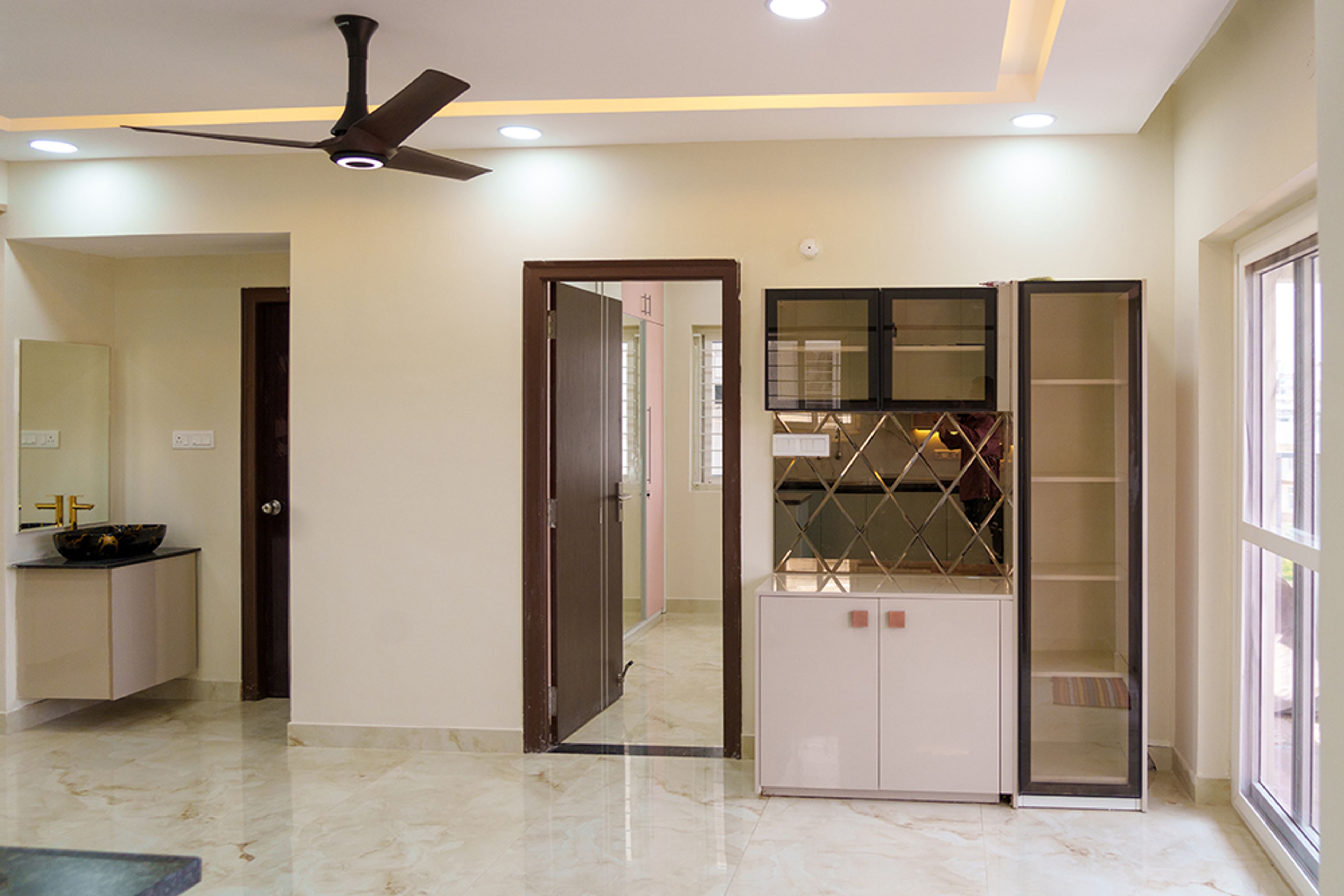 Crockery Unit Design with Beige Cabinets and Glass Shutter Tall Unit