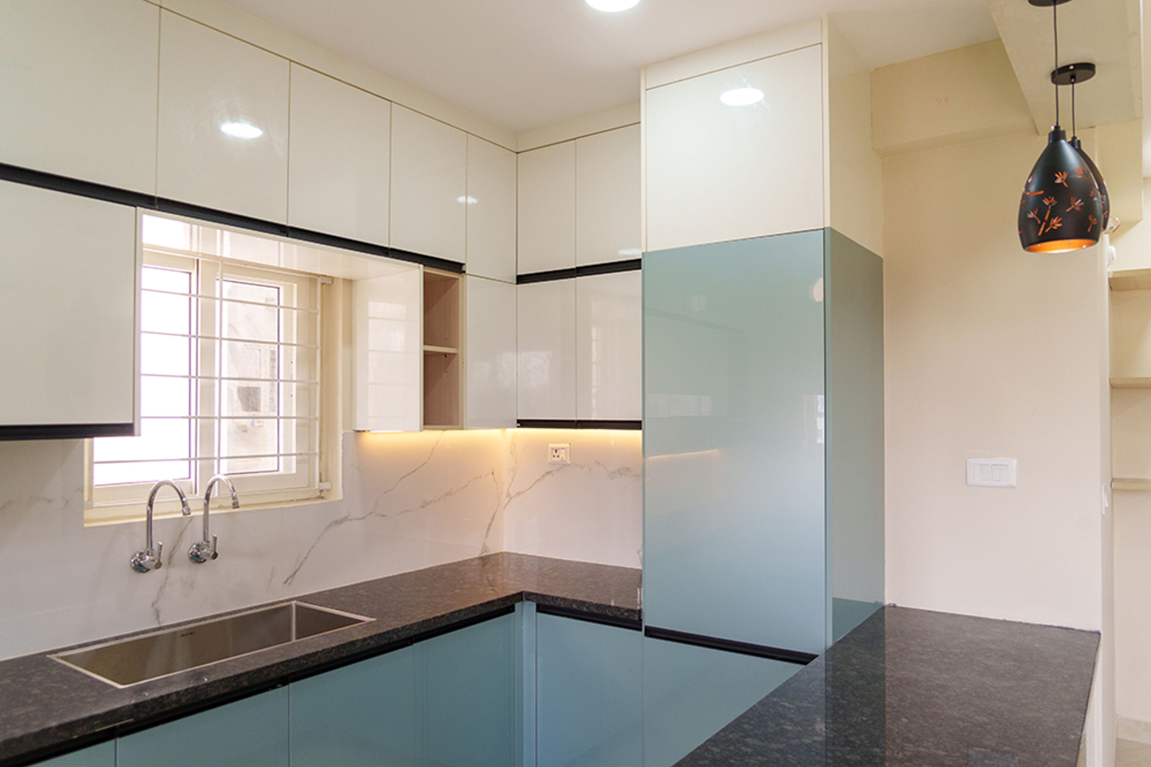 U-Shaped Kitchen Design with Aqua Blue Base Cabinets and Black Granite Countertop