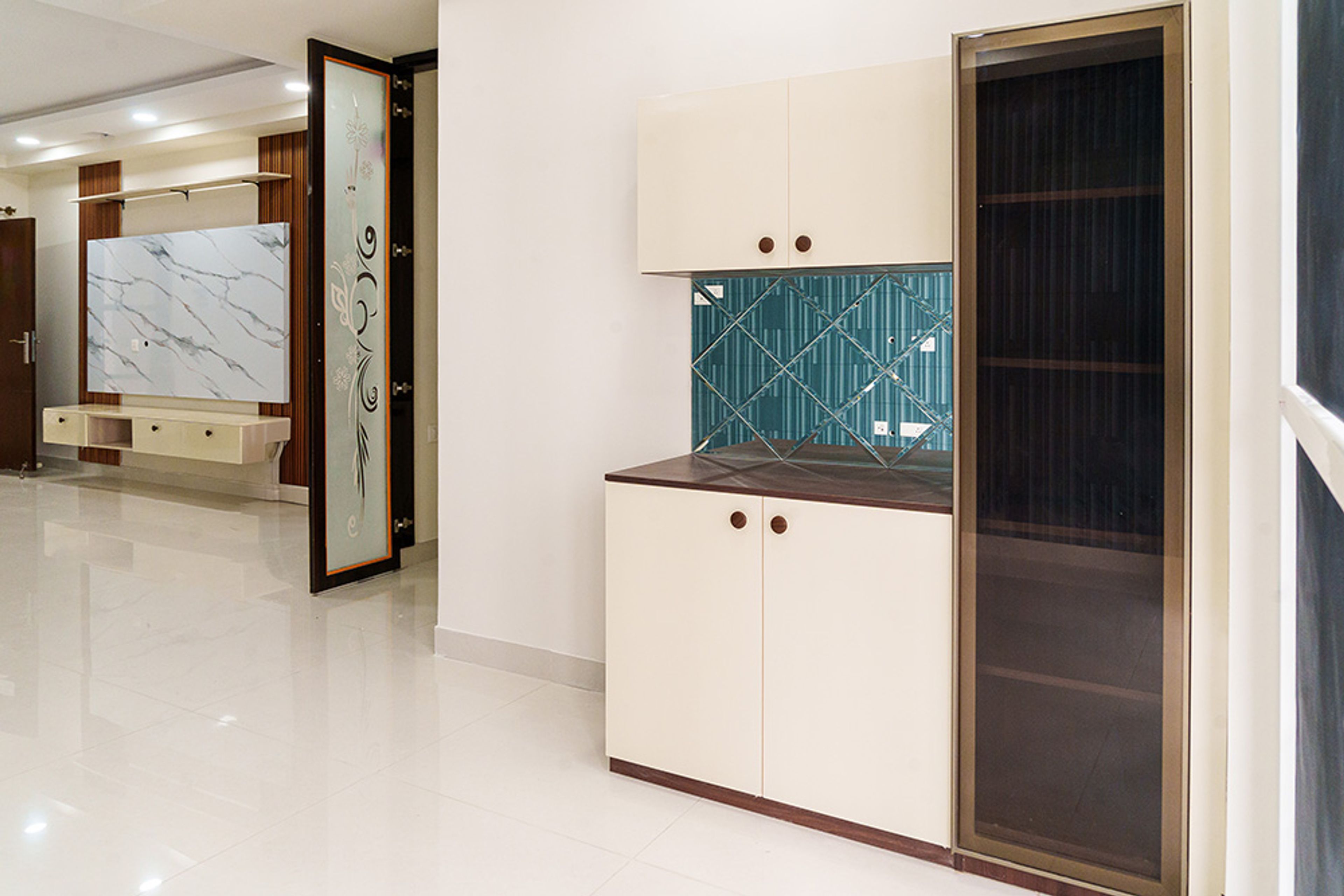 Crockery Unit Design with Cabinets and Tall Unit with Glass Shutters