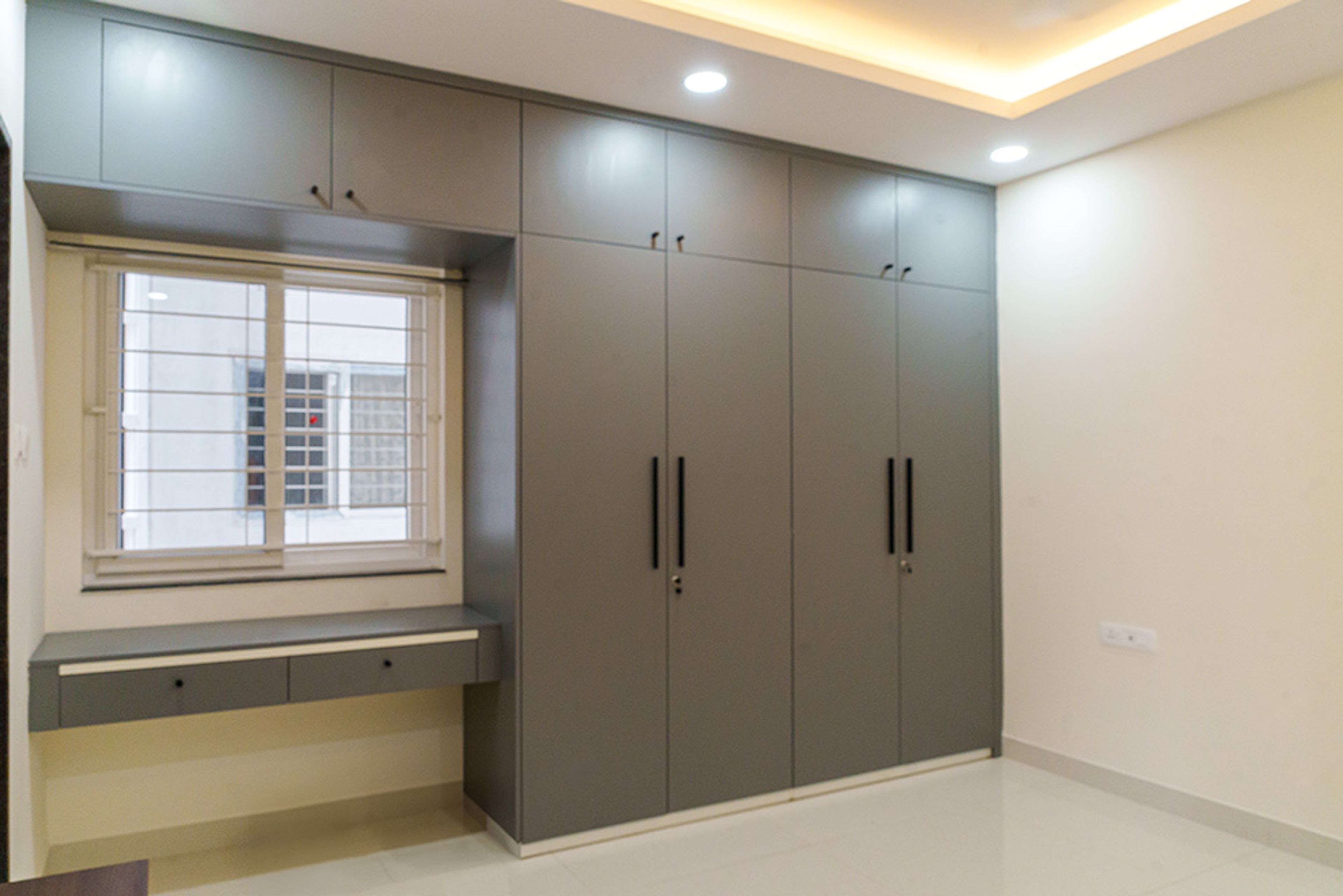4-Door Grey Swing Wardrobe Design with Loft Unit