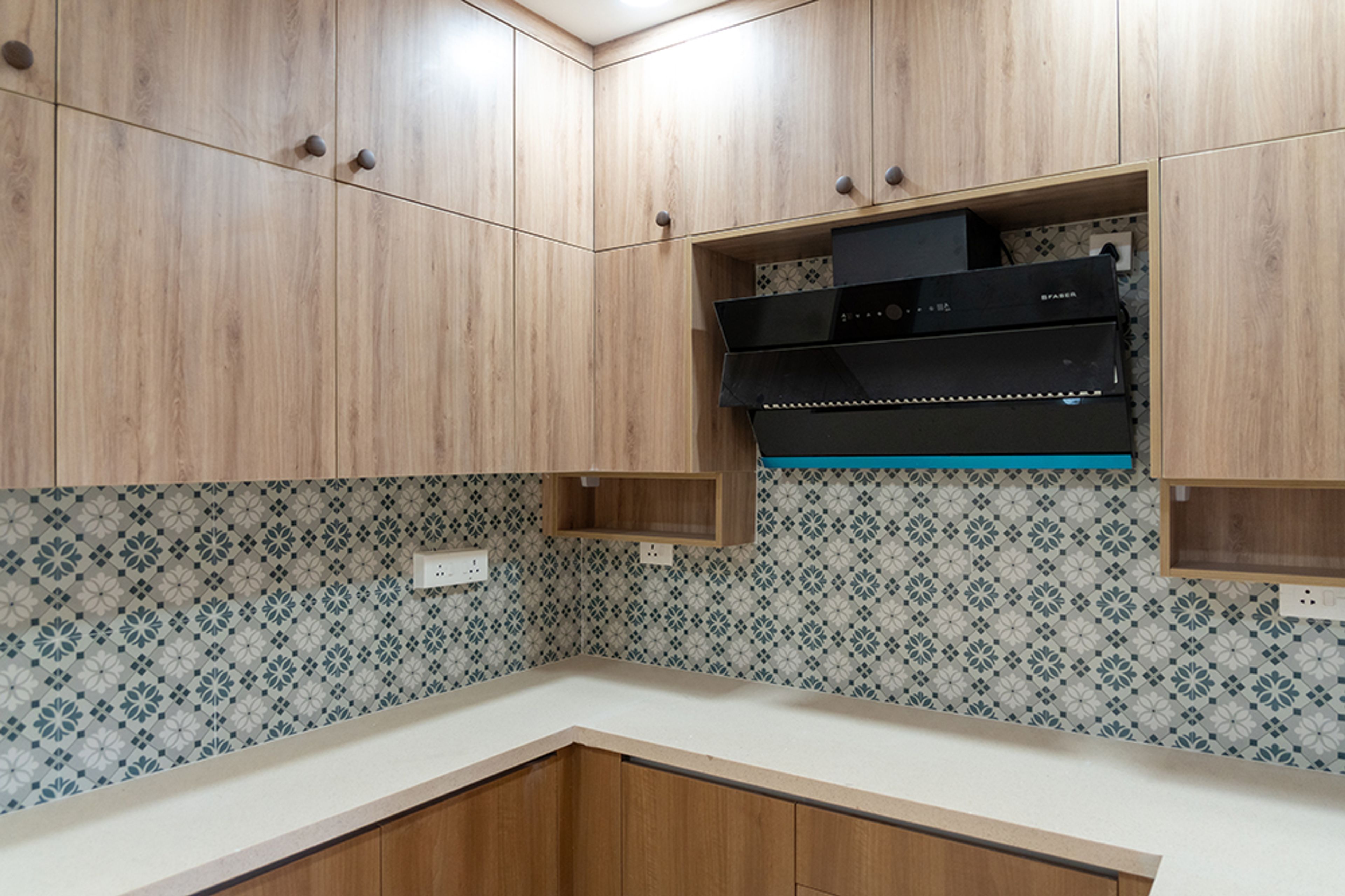 U-Shaped Kitchen Design with Wooden Units and Moroccan Backsplash