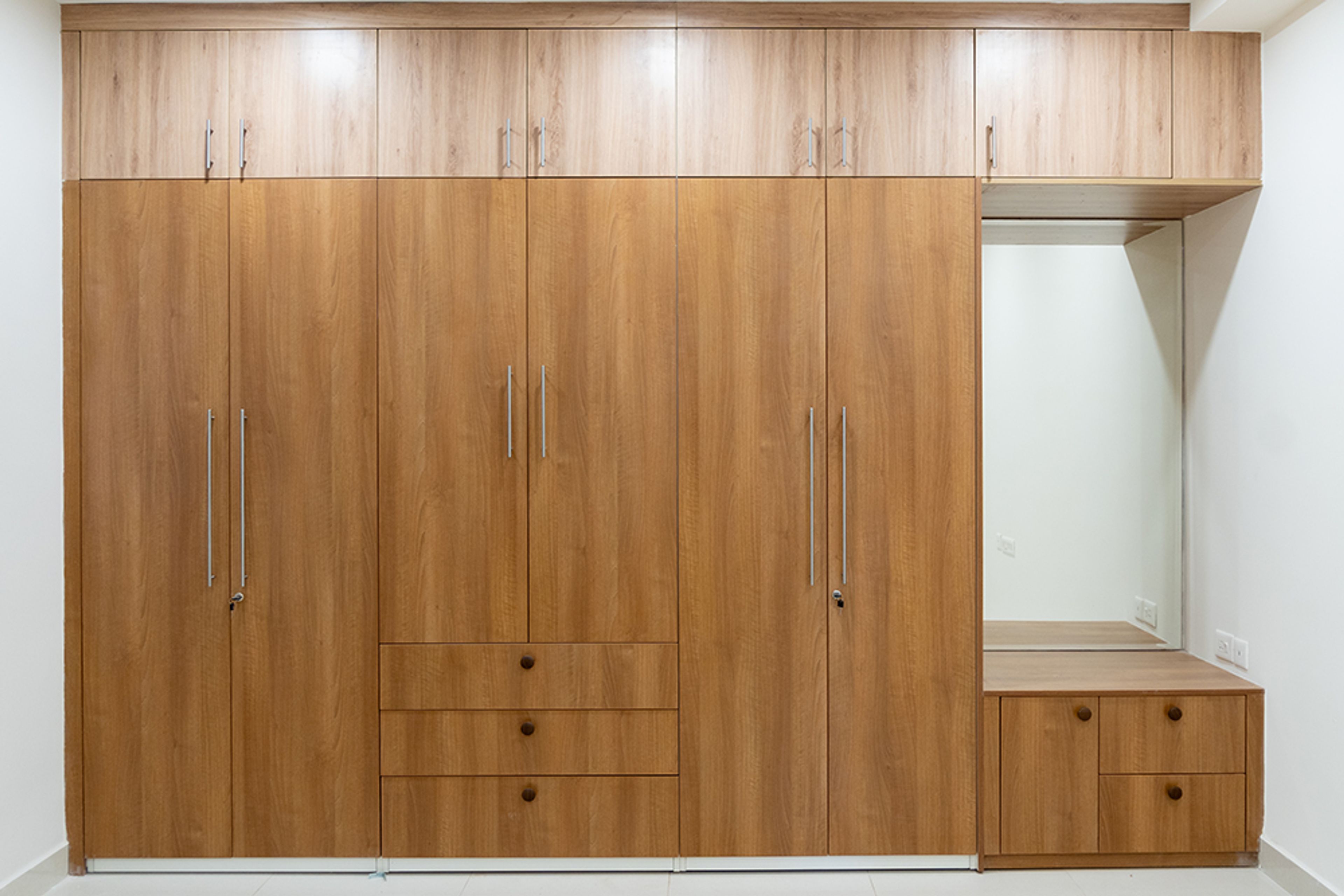 6-Door Brown Wood Swing Wardrobe Design with Attached Dressing Unit