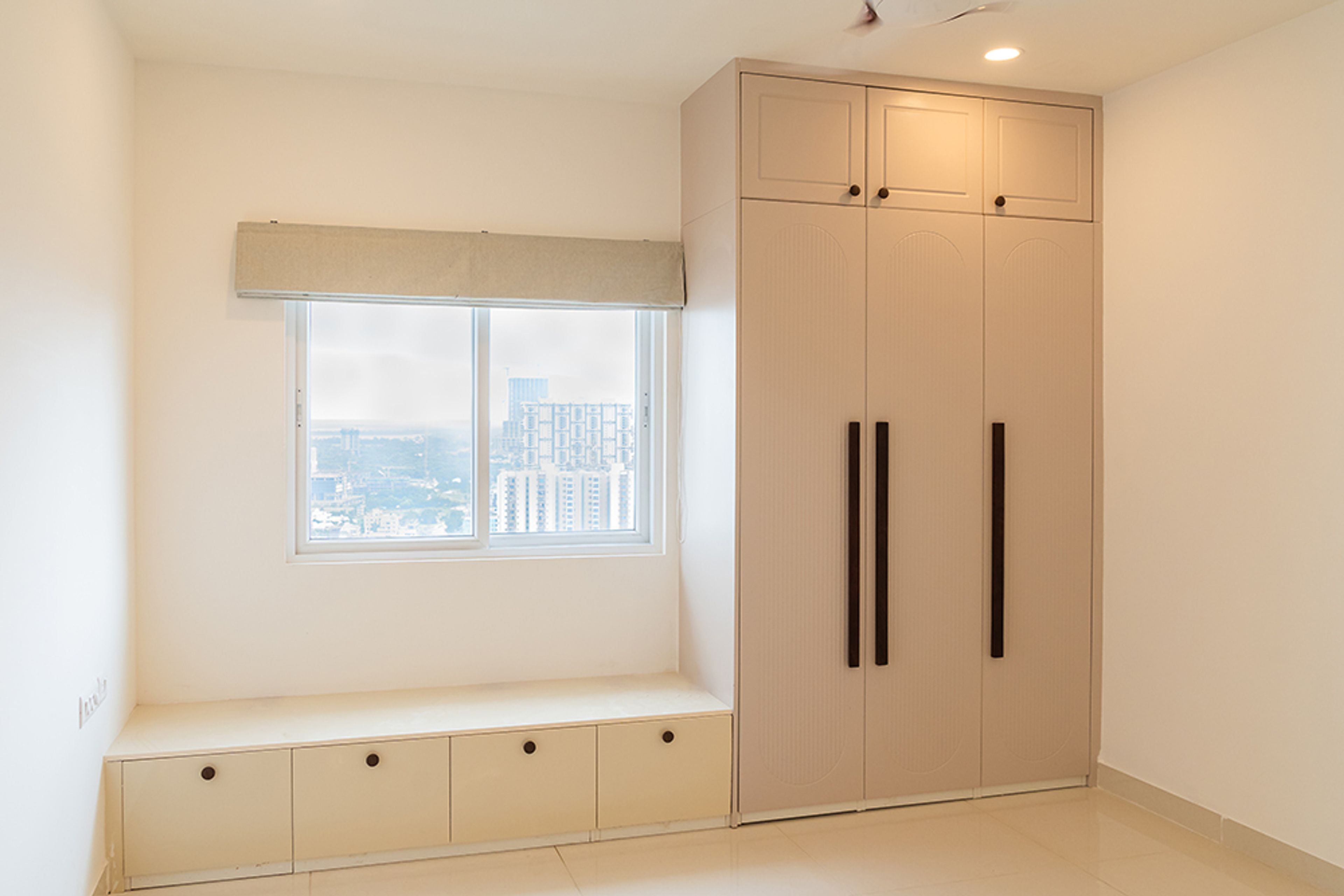 Bedroom Design with Beige 3-Door Swing Wardrobe and Seating Space with Storage
