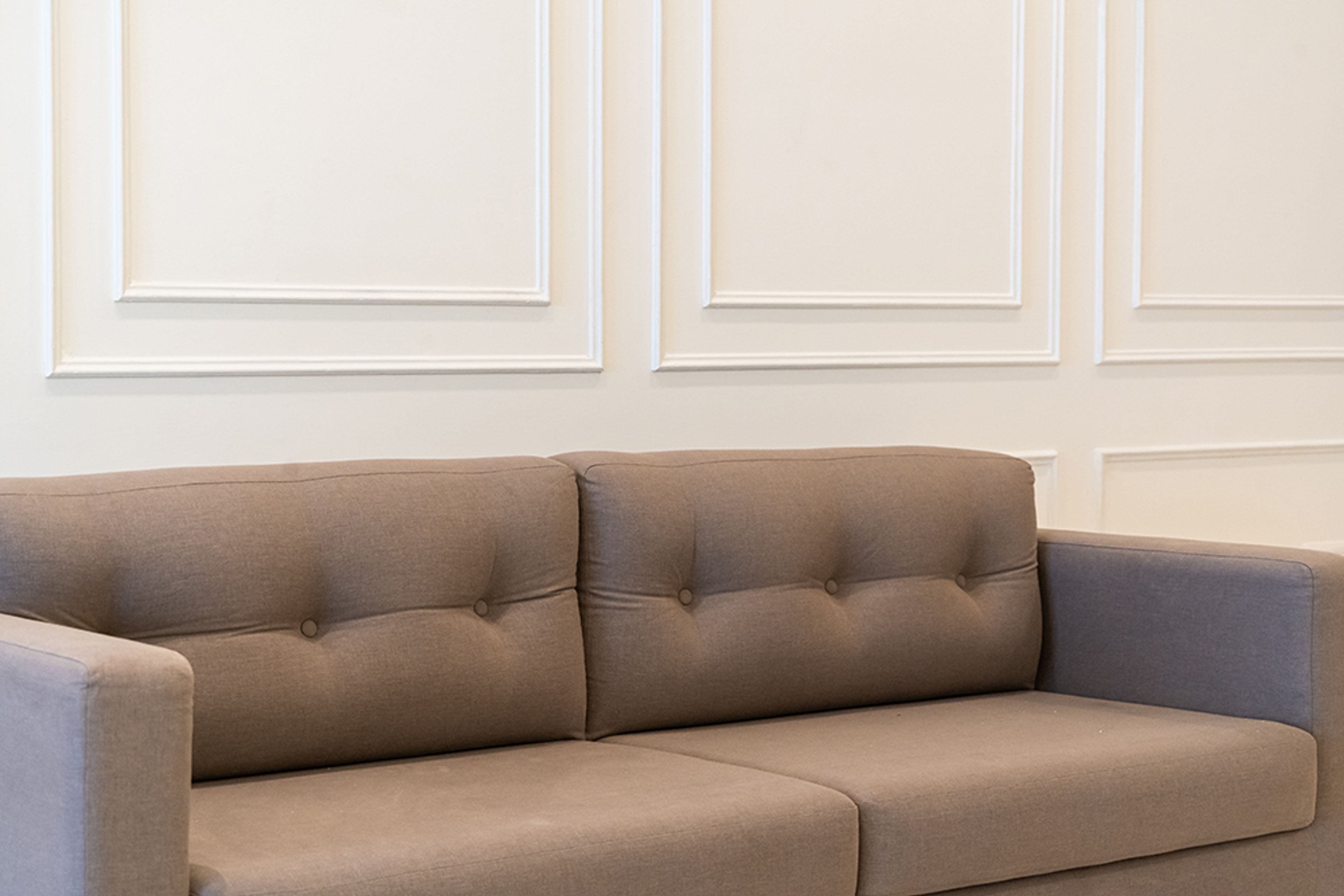 Living Room Design with Brown Sofa and White Wall with Trims