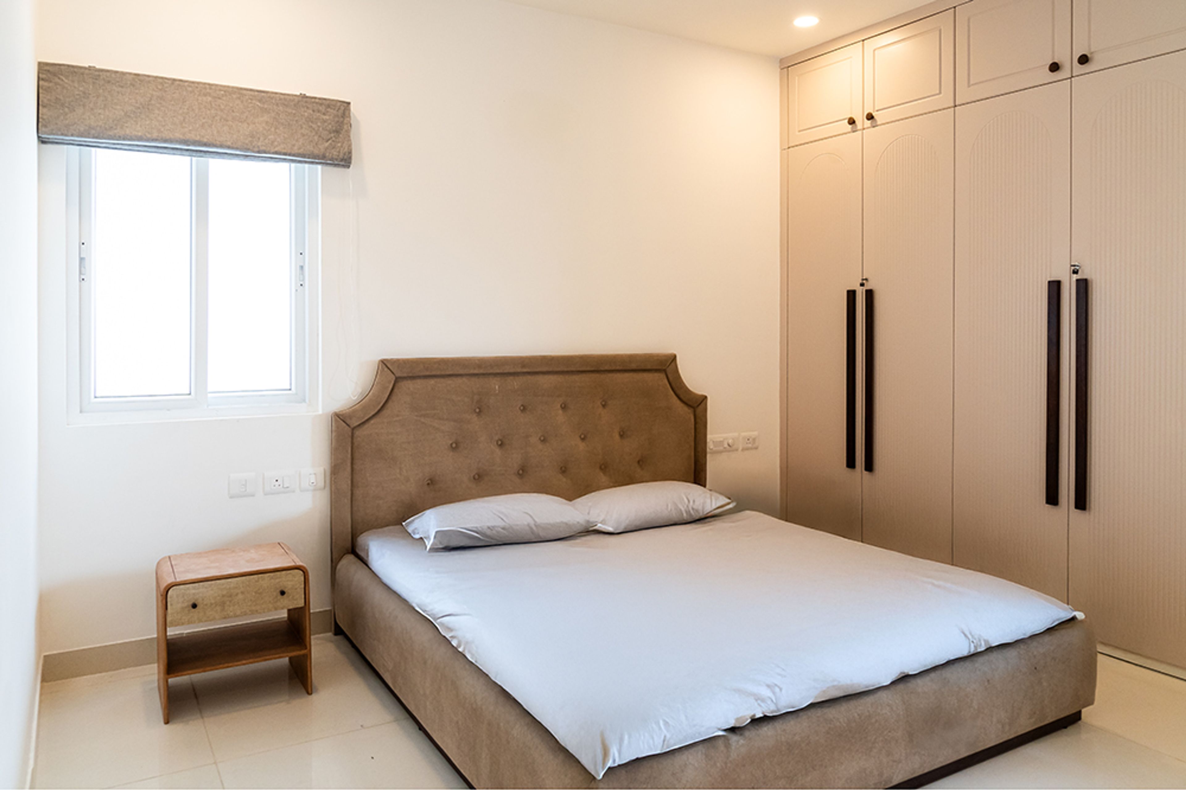 Bedroom Design with Brown Tufted Headboard Bed and 4-Door Swing Wardrobe